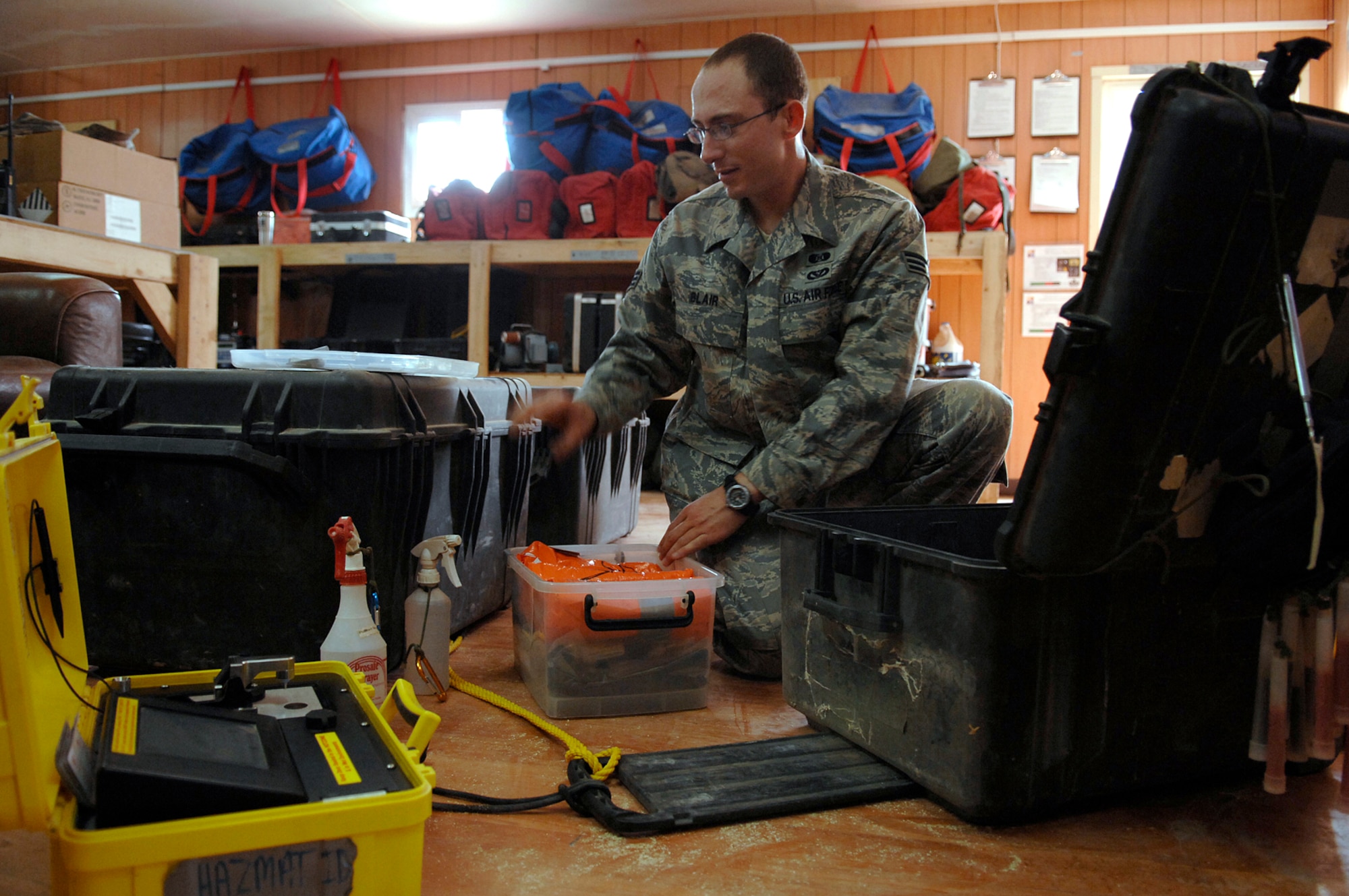 JOINT BASE BALAD, Iraq -- Senior Airman Michael Blair, 332nd Expeditionary Civil Engineer Squadron emergency management equipment technician, pieces together a 12-cubic-foot box used to hold instruments needed for responding to hazardous material situations here July 12. The kit replaces a previous four-case response package. Using one response kit instead of three or four has cut the 332nd ECES' Emergency Management Flight's response time by more than 75 percent. Airman Blair is deployed from McGuire Air Force Base, N.J. (U.S. Air Force photo/ Senior Airman Julianne Showalter)