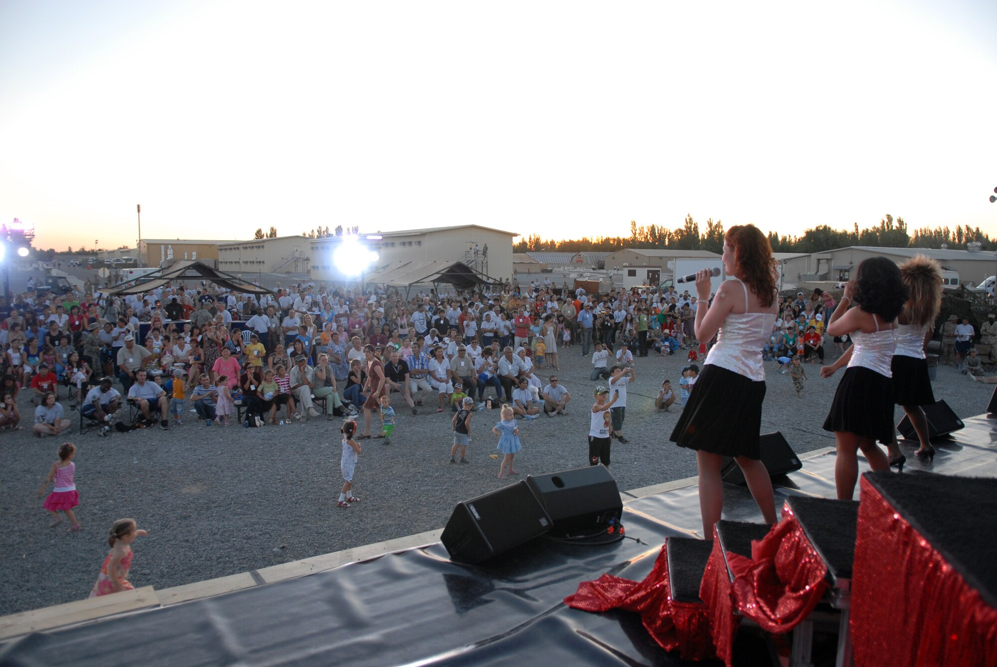 MANAS AIR BASE, Kyrgyz Republic -- Tops in Blue members perform for the Manas Air Base contractor and family appreciation day, July 11, at Manas AB, Kyrgyz Republic. Roughly 600 local Kyrgyz and hundreds of Airmen attended the activities, which included face painting, a dunk tank and barbeque. The evening's events concluded with a concert by Tops in Blue, the Air Force's premier entertainment show. (U.S. Air Force photo / Airman 1st Class Ruth Holcomb)