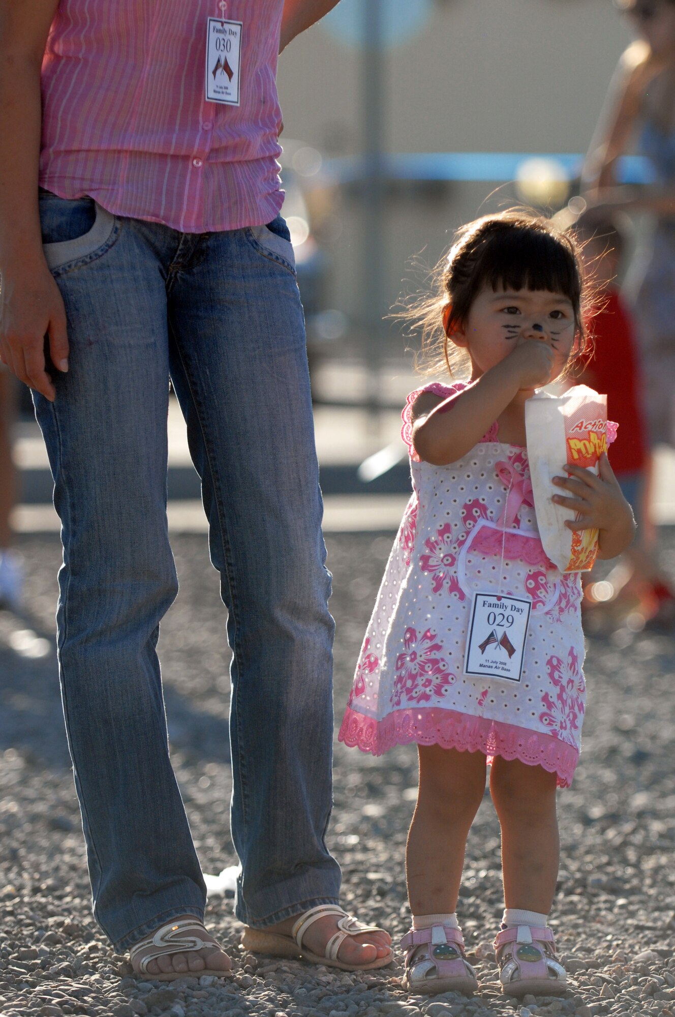 MANAS AIR BASE, Kyrgyz Republic -- A Kyrgyz Republic child enjoys some popcorn during the Manas Air Base contractor and family appreciation day, July 11, at Manas AB, Kyrgyz Republic. Roughly 600 guests attended the activities ranging from face painting, barbeque, and a Tops in Blue concert. (U.S. Air Force photo / Airman 1st Class Ruth Holcomb)