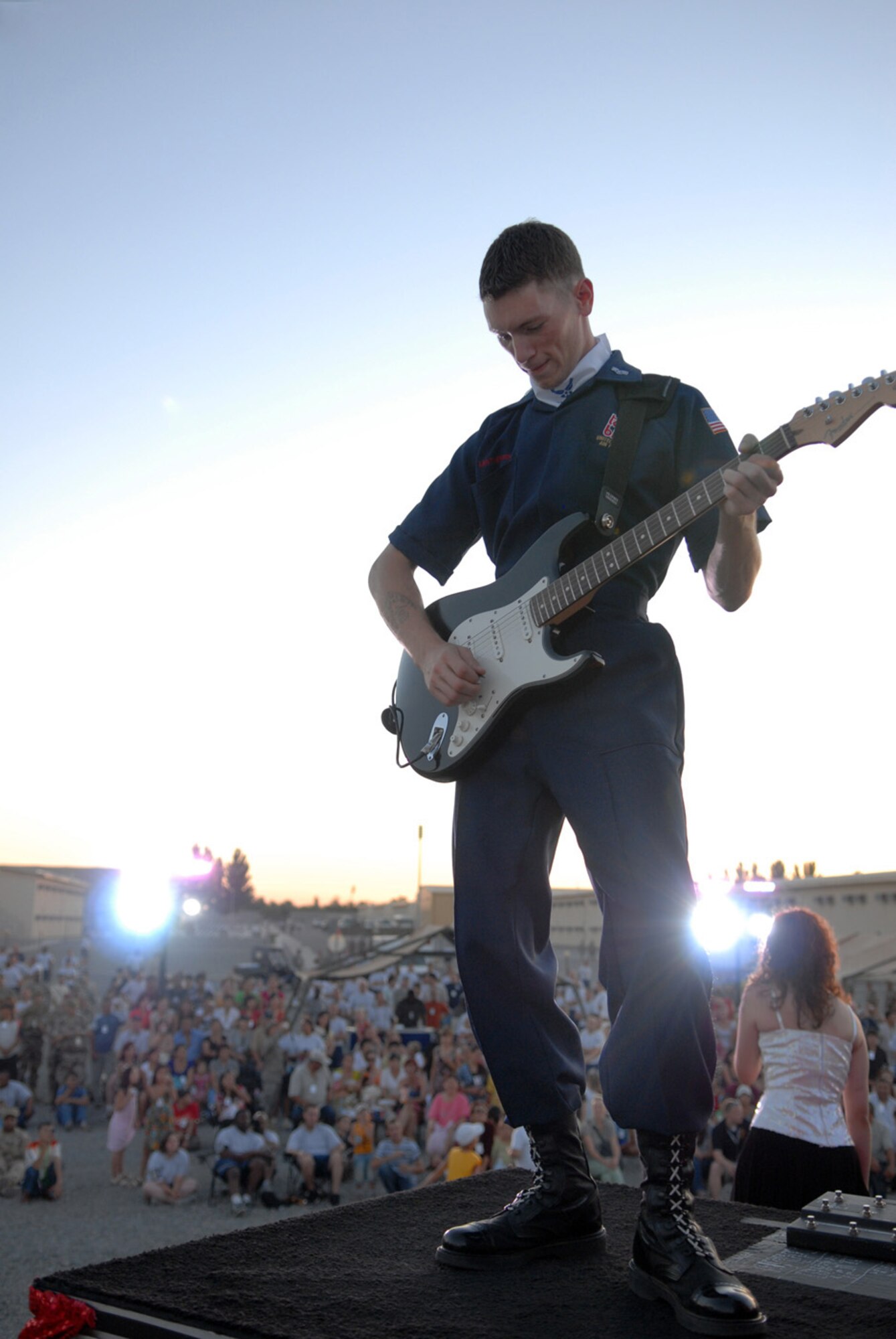MANAS AIR BASE, Kyrgyz Republic -- Senior Airman Davey Leatherwood, Tops in Blue guitarist, performs here during a concert for the Manas Air Base contractor and family appreciation day, July 11. Roughly 600 guests attended the activities, which included a barbeque, face painting and a Tops in Blue concert. (Air Force photo / Airman 1st Class Ruth Holcomb)