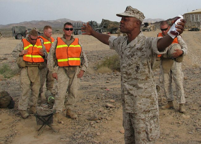 Lt. Cmdr. Kobena Arthur, the chaplain with 2nd Battalion, 25th Marine Regiment, Regimental Combat Team 5, leads Marines from Echo Company, 2nd Bn., 25th Marines in prayer during a field religious service prior to a training exercise at Range 400 aboard Marine Corps Air Ground Combat Center Twentynine Palms, Calif., July 12. The reserve battalion's current deployment to Iraq is their second in support of Operation Iraqi Freedom.::r::::n::::r::::n::