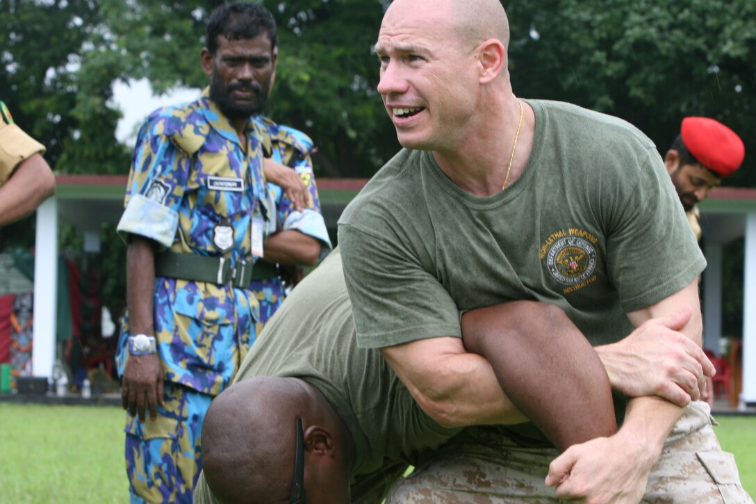Gunnery Sgt. Dennis Dodd demonstrates how to apply mechanical advantage control/hold three July 13 during Non-Lethal Weapons Executive Seminar 2008, here. Dodd is the senior anti-terrorism force protection instructor with III Marine Expeditionary Force's Special Operations Training Group.