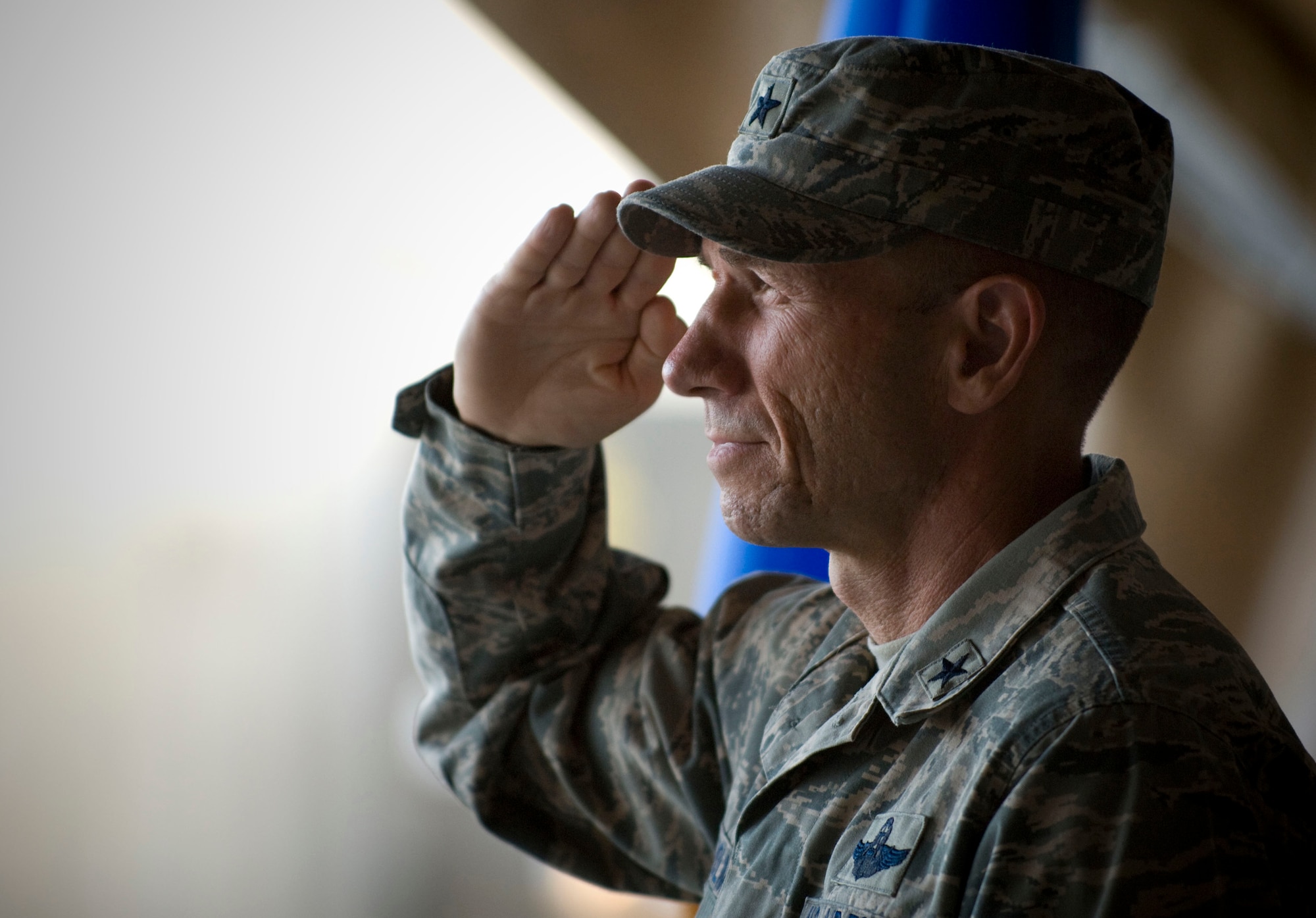 BAGRAM AIR FIELD, Afghanistan -- Brig. Gen. James Holmes, commander of the 455th Air Expedtionary Wing, salutes the flag during the singing of the national anthem here on July 10, 2008. General Holmes presided over the 455th Expeditionary Mission Support Group's change of command ceremony. General Holmes remarked, "I don't know if it's the time of day that I really enjoy ... listening to the national anthem, being played on the dusty planes of Afghanistan ... it's just a good moment, I think, to be here."(U.S. Air Force photo by Staff Sgt. Samuel Morse)