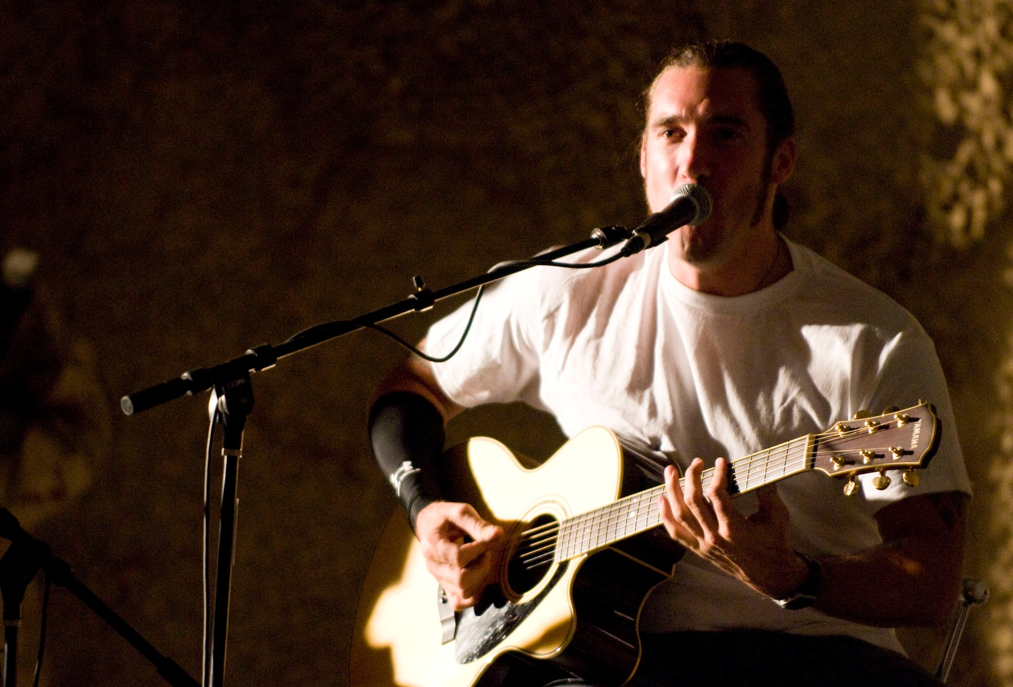 BAGRAM AIR FIELD, Afghanistan -- Guitarist Clint Lowery, from rock group "Sevendust" plays and sings a mocking death metal rendition of "Jesse's Girl" during a performance here on July 12, 2008. "Sevendust," from Atlanta, Ga., gave a USO-sponsored tour throughout Southwest Asia, performing for deployed coalition forces. (U.S. Air Force photo by Staff Sgt. Samuel Morse)