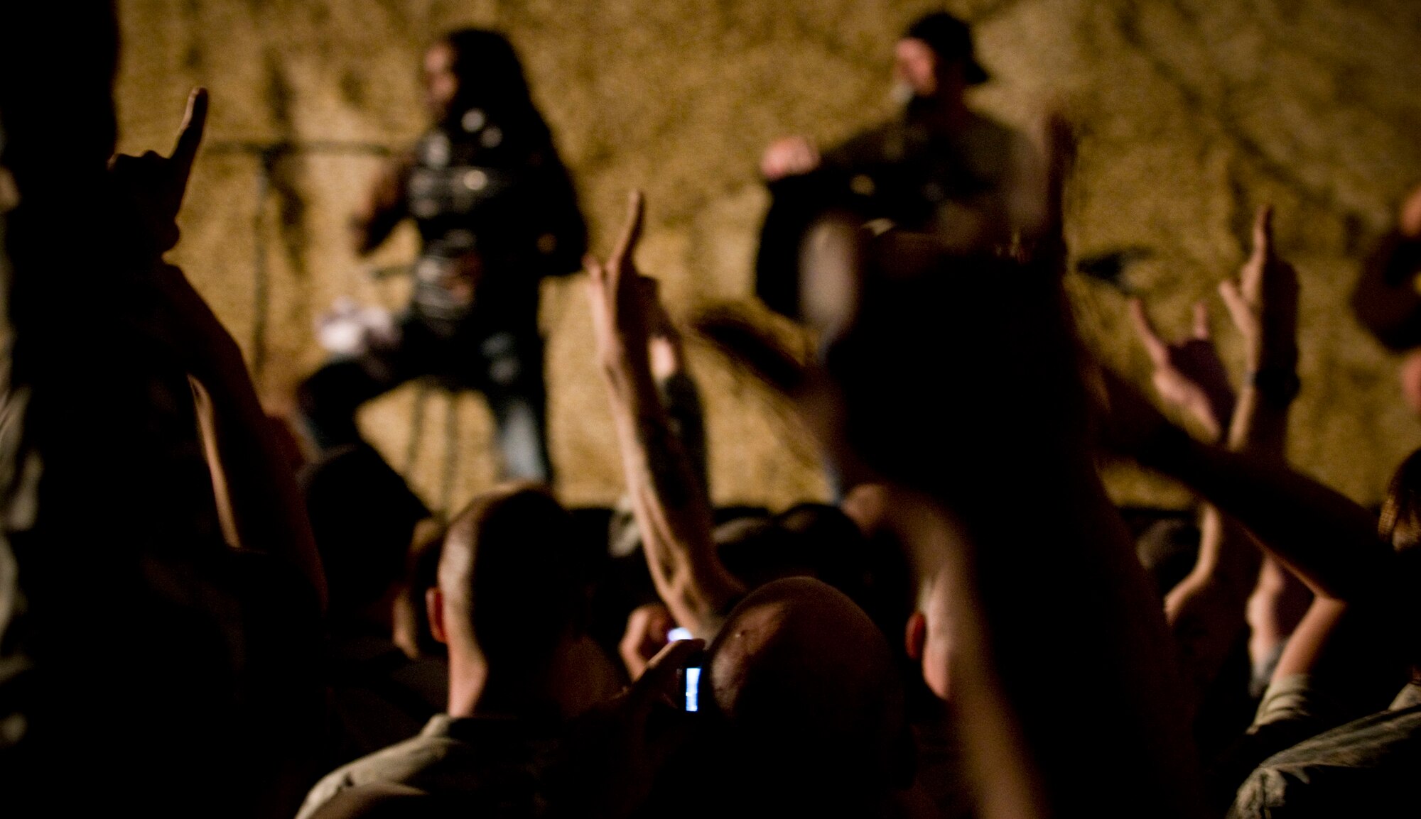 BAGRAM AIR FIELD, Afghanistan -- Fans of rockgroup "Sevendust" show their appreciation during a performance here on July 12, 2008. "Sevendust," from Atlanta, Ga., gave a USO-sponsored tour throughout Southwest Asia, performing for deployed coalition forces. (U.S. Air Force photo by Staff Sgt. Samuel Morse)