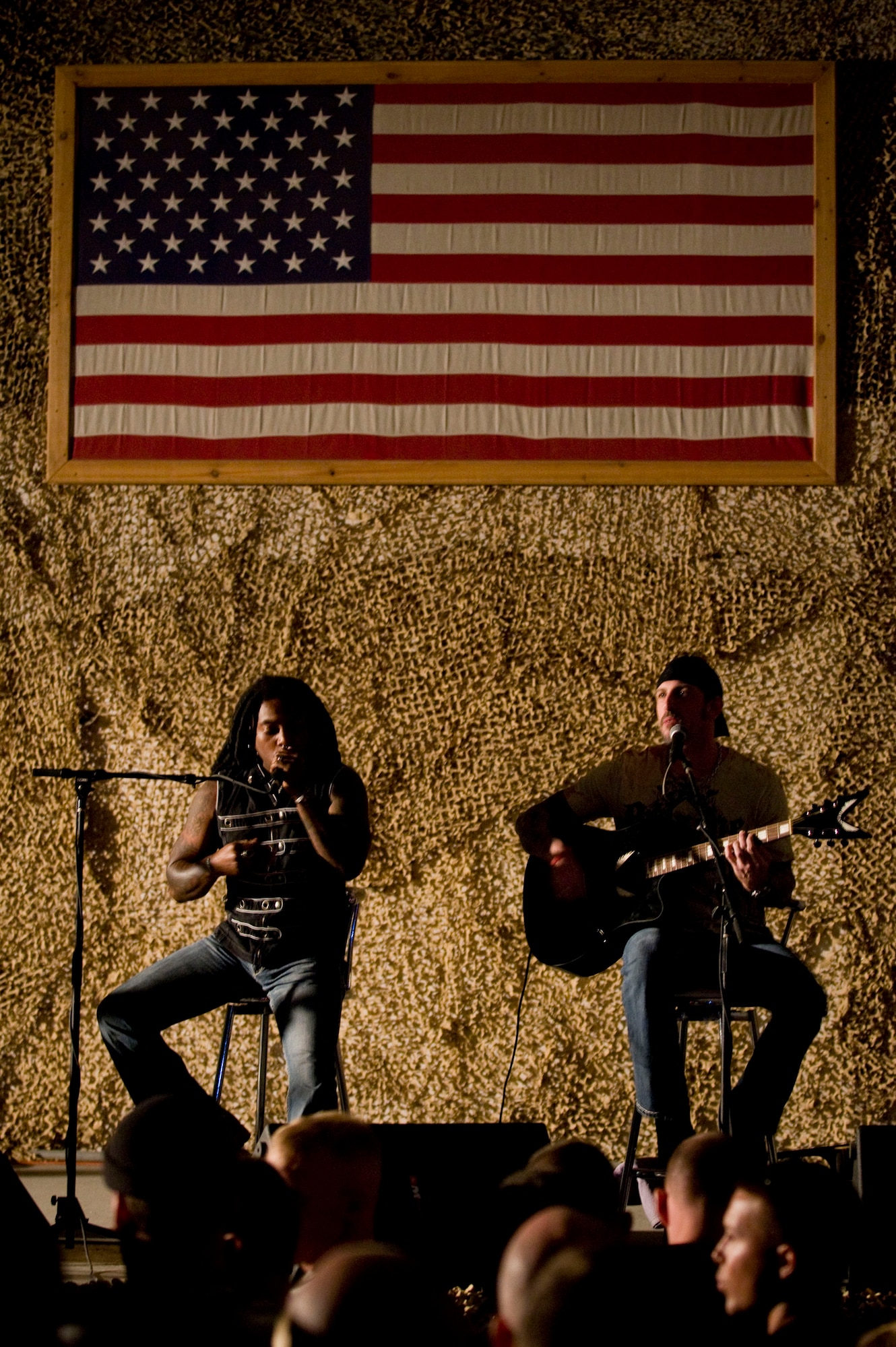 BAGRAM AIR FIELD, Afghanistan -- Vocalist Lajon Witherspoon and guitarist John Connolly from rock band "Sevendust" perform here on July 12, 2008. "Sevendust," from Atlanta, Ga., gave a USO-sponsored tour throughout the Southwest Asia, performing for deployed coalition forces. (U.S. Air Force photo by Staff Sgt. Samuel Morse)