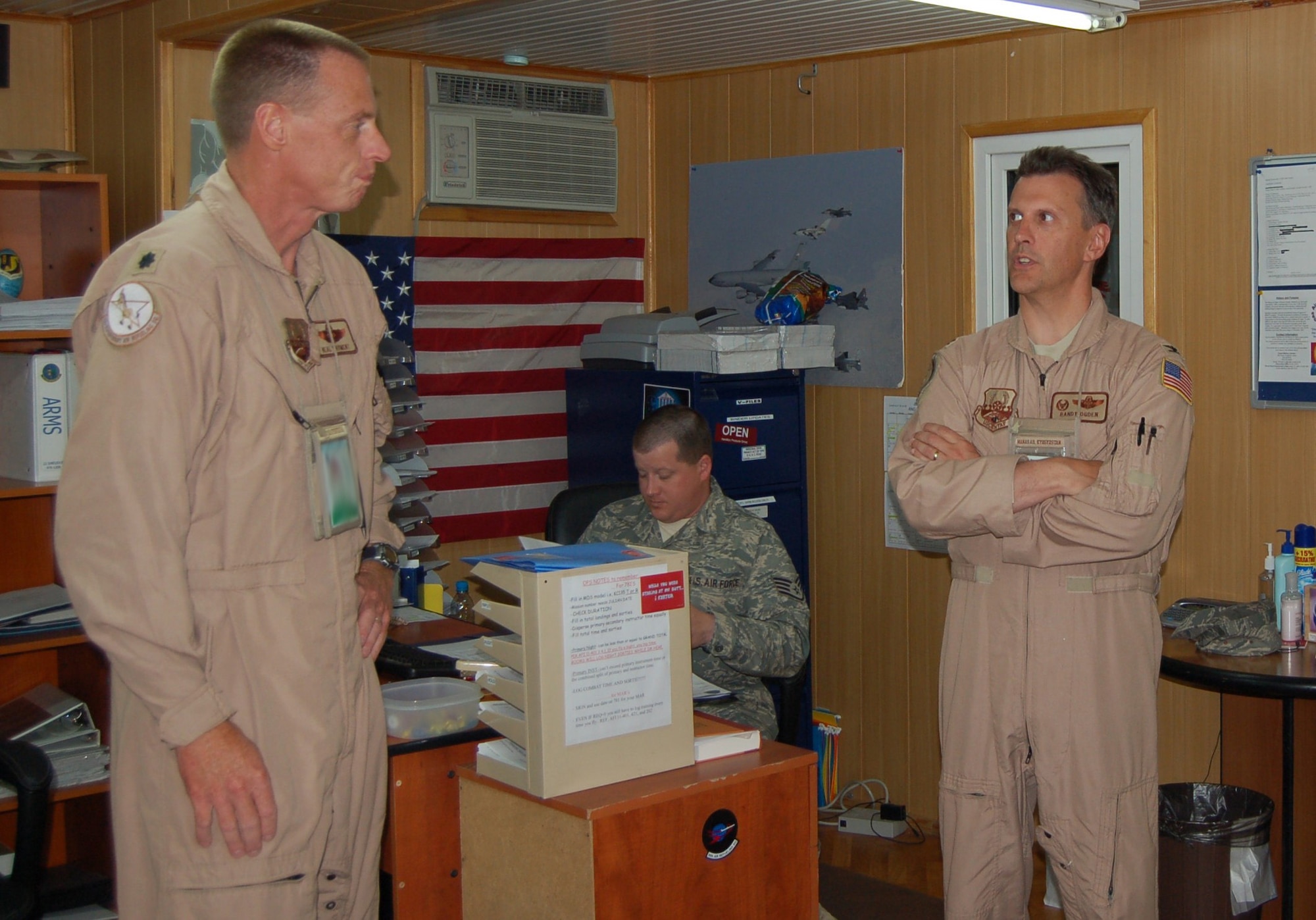 MANAS AIR BASE, Kyrgyz Republic --Lt. Col. Neal Wayment, 22nd Expeditionary Air Refueling Squadron Director of Operations, discusses daily flying operations July 12 with Col. Randy Ogden, 376th Expeditionary Operations Group commander. Colonel Wayment, the 151st Air Refueling Wing's Operations Support Flight commander, is deployed to Manas Air Base, Kyrgyz Republic, with more than 130 other Guardsmen from the Salt Lake City Air National Guard unit. Four of the 151st ARW's KC-135 Stratotankers are providing refueling support for military operations in Afghanistan.  (Air Force photo / Maj. Damien Pickart)