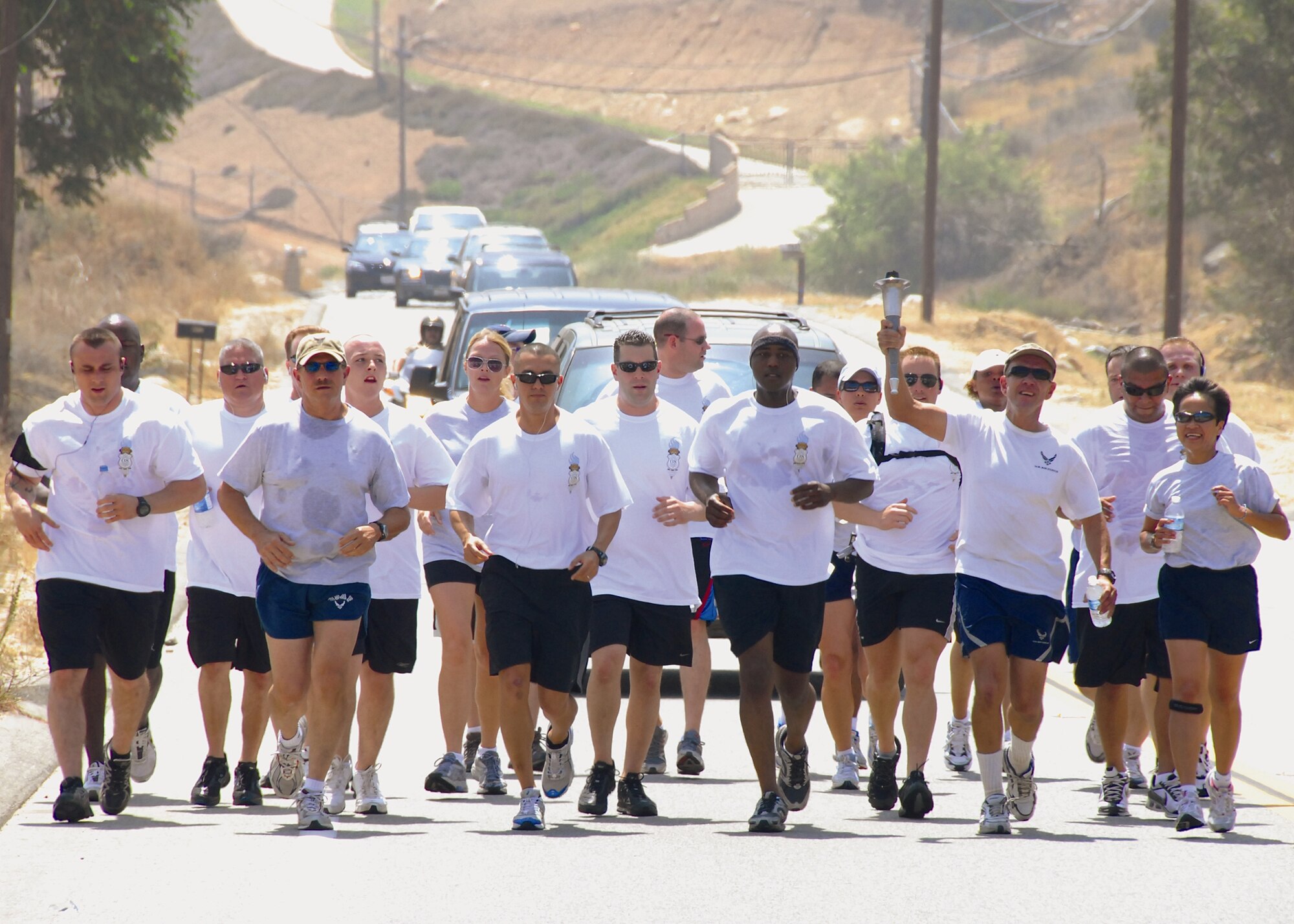 Members of the 452nd Air Mobility Wing's Security Forces Squadron and the 163 Reconnaisasnce Wing participate in a five-mile relay along with various law enforcement agencies during an annual Torch Run event supporting the Special Olympics. The event kicked-off with volunteers running portions of the approximately 410-mile journey, which began in San Diego and wound throughout Southern California ending in Long Beach. (U.S. Air Force photo by Master Sgt. Stan Thompson/163RW)