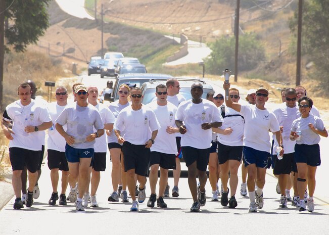 Members of the 452nd Air Mobility Wing's Security Forces Squadron and the 163 Reconnaisasnce Wing participate in a five-mile relay along with various law enforcement agencies during an annual Torch Run event supporting the Special Olympics. The event kicked-off with volunteers running portions of the approximately 410-mile journey, which began in San Diego and wound throughout Southern California ending in Long Beach. (U.S. Air Force photo by Master Sgt. Stan Thompson/163RW)