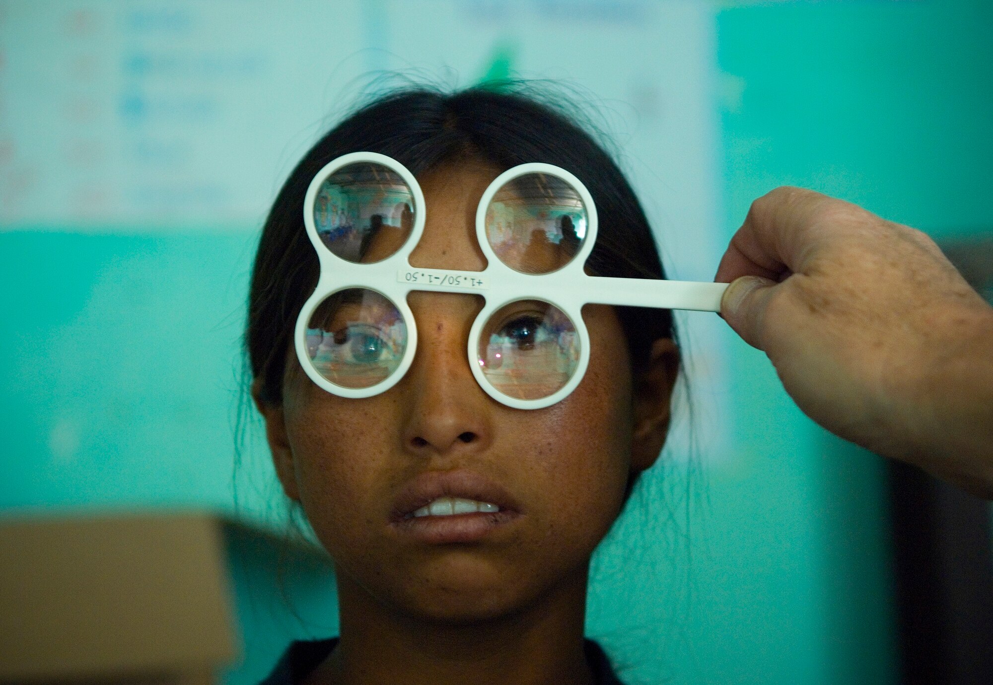 Jessica Henes, 9, gets a free eye exam. (U.S. Air Force photo by Staff Sgt. Bennie J. Davis III)