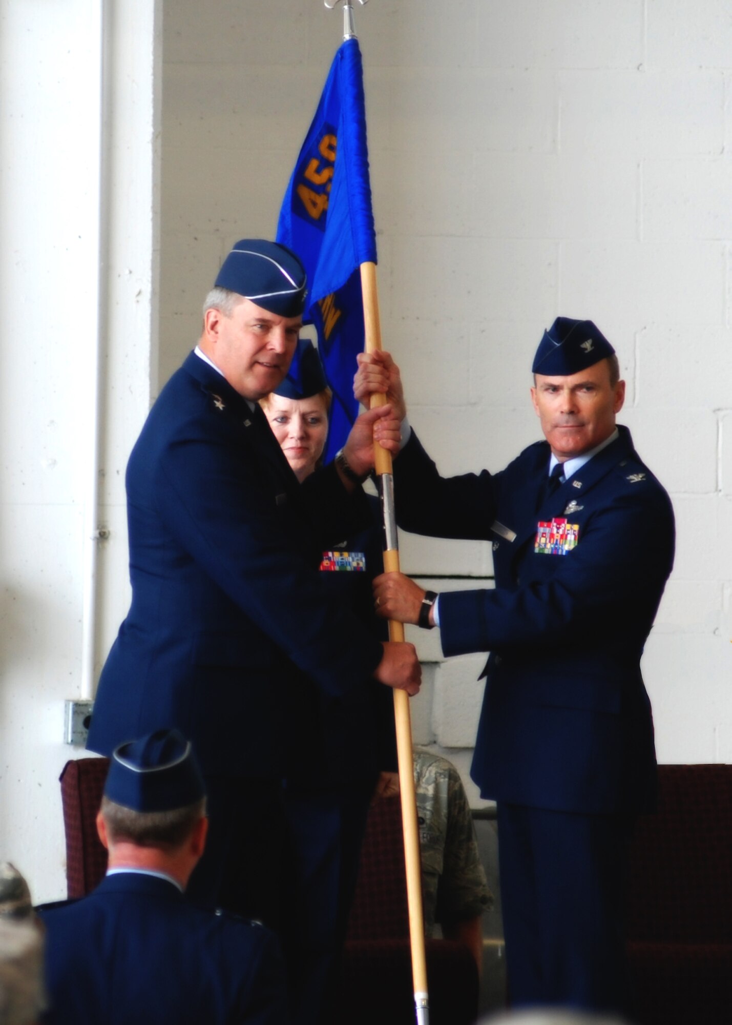 ANDREWS AIR FORCE BASE, Md. -- Maj. Gen. Robert E. Duignan, 4th Air Force commander, presents the 459th Air Refueling Wing guidon to Col. Tim Cahoon at the change of command ceremony here July 13. Current 459th Air Refueling Wing Commander Col. Stayce D. Harris relinquished the guidon and Col. Tim Cahoon, current 459th ARW vice commander, officially assumes command Aug. 1. (Center) Chief Master Sgt. Patti Hickman, 459th ARW command chief, looks on. (U.S. Air Force photo/Tech. Sgt. Eric Sharman)