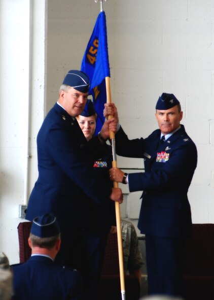 ANDREWS AIR FORCE BASE, Md. -- Maj. Gen. Robert E. Duignan, 4th Air Force commander, presents the 459th Air Refueling Wing guidon to Col. Tim Cahoon at the change of command ceremony here July 13. Current 459th Air Refueling Wing Commander Col. Stayce D. Harris relinquished the guidon and Col. Tim Cahoon, current 459th ARW vice commander, officially assumes command Aug. 1. (Center) Chief Master Sgt. Patti Hickman, 459th ARW command chief, looks on. (U.S. Air Force photo/Tech. Sgt. Eric Sharman)