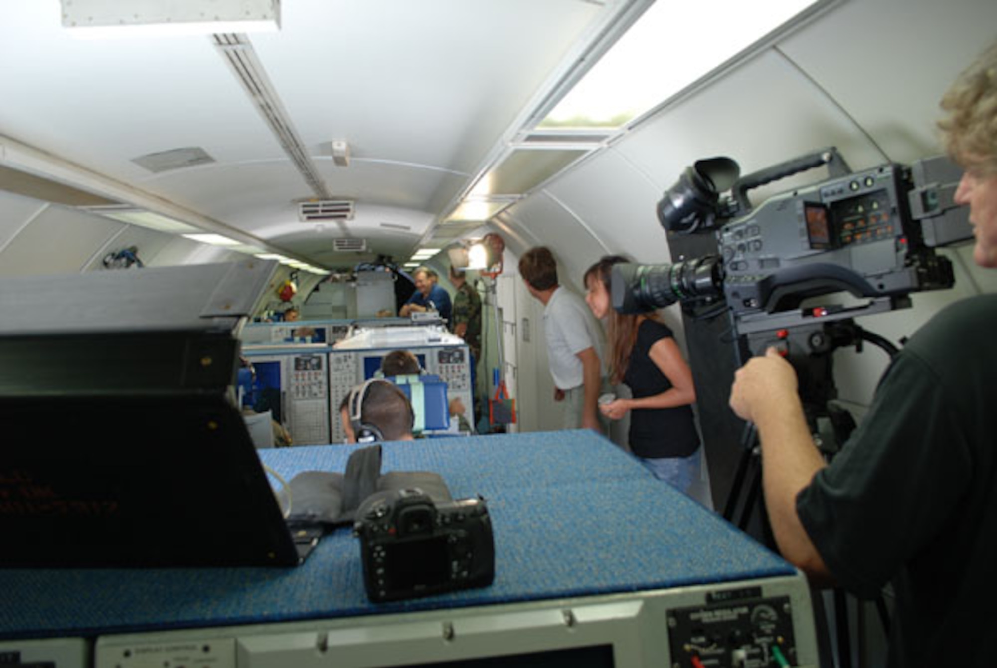 While 513th Air Control Group aircrew members work at their E-3 consols during a training tape simulation, film crews work to video tape the action. These Air Force Reservists and additional members of the 513th ACG Maintenance Squadron participated in the production of an Air Force Reserve television commercial for the Airborne Warning and Control Systems career field earlier this month.  