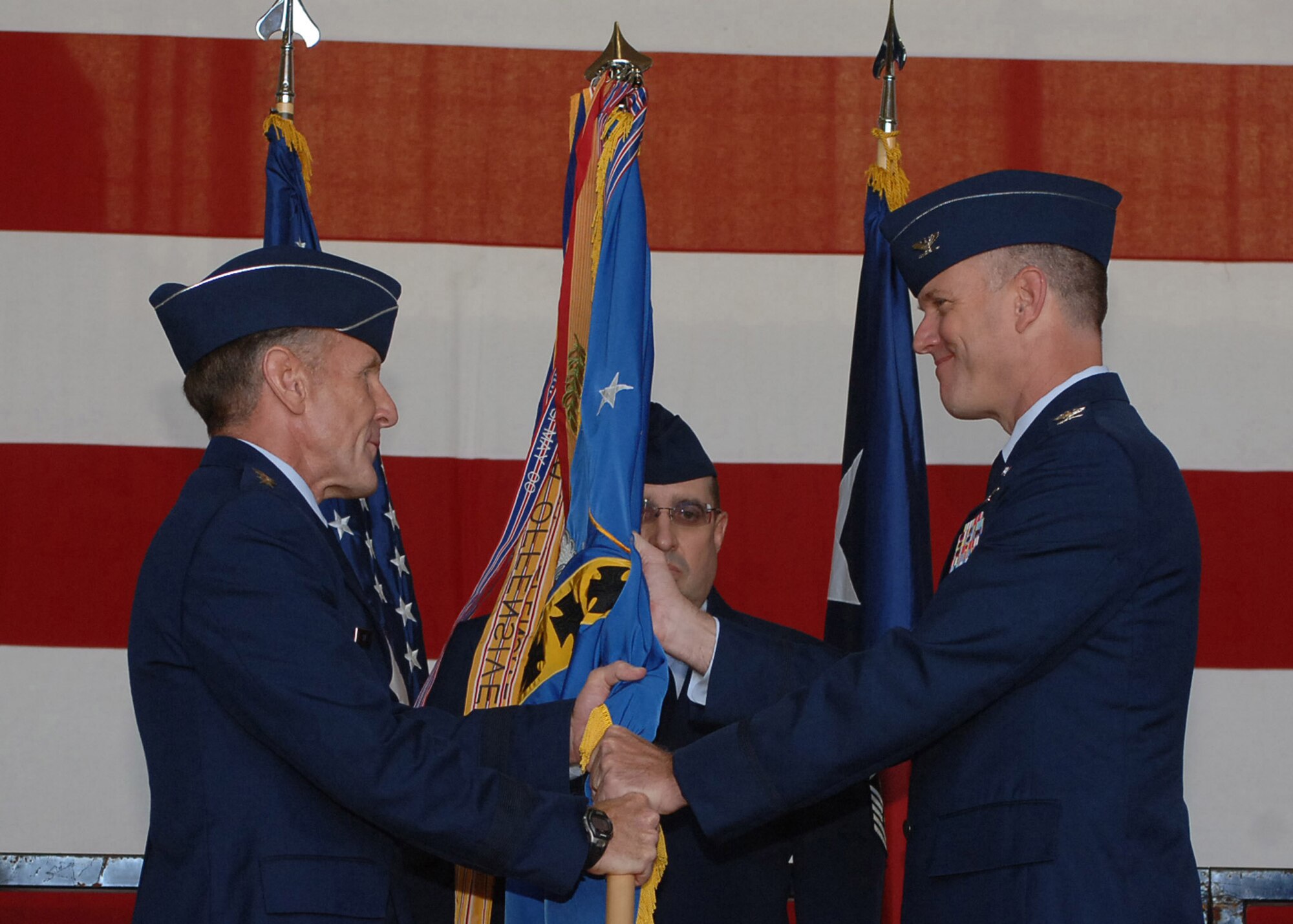 DYESS AIR FORCE BASE, Texas -- Colonel Robert Gass accepts command of the 7th Bomb Wing from Lt. Gen. Norman Seip, 12th Air Force commander, during the change of command ceremony here July 11. Colonel Gass assumed command from Col. Timothy Ray, who served as Dyess's commander for two years.  (U.S. Air Force Photo by Senior Airman Felicia Juenke).