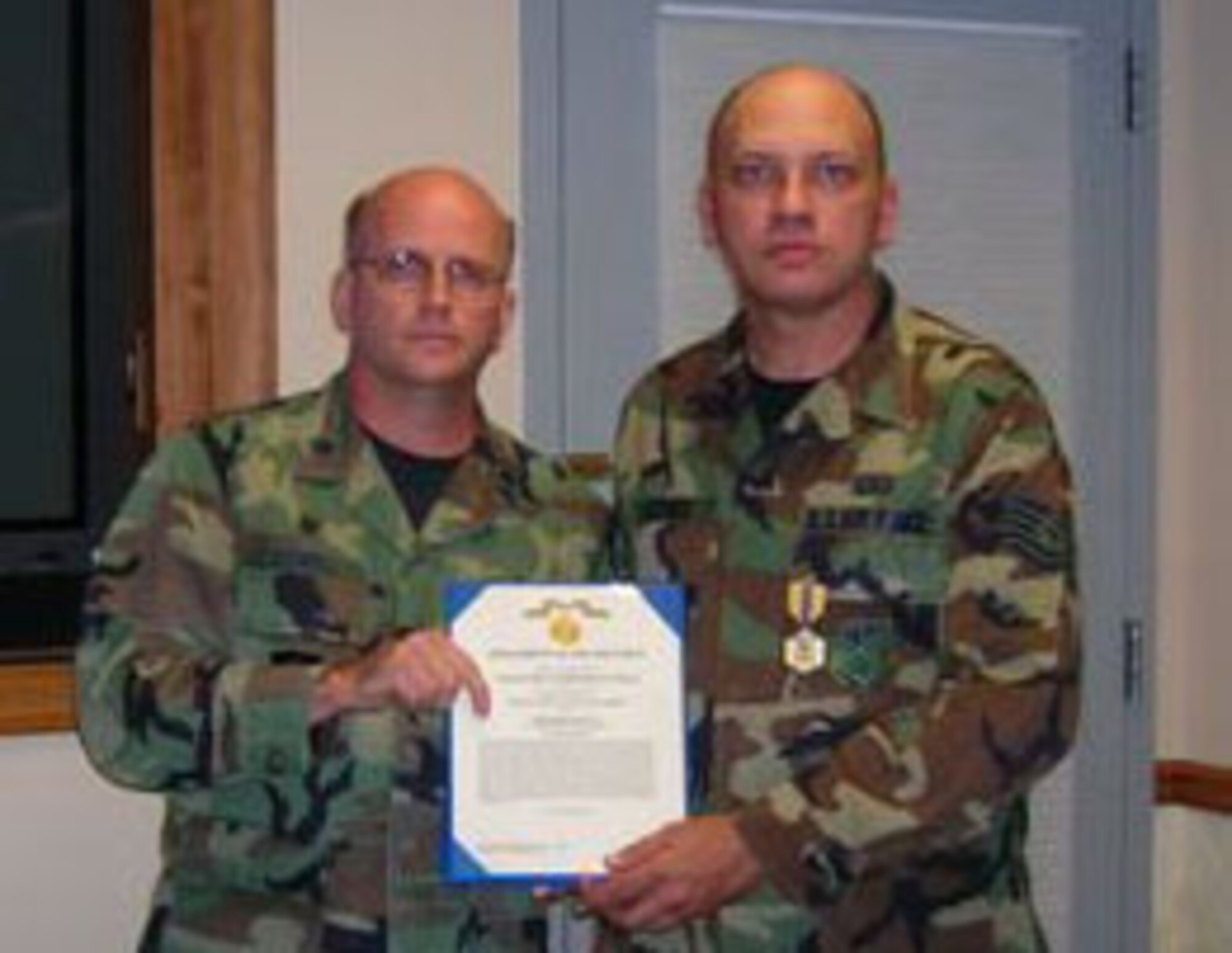 SEYMOUR JOHNSON AIR FORCE BASE, N.C. -- Tech. Sgt. William Keerbs (right) retires this weekend with more than 20 years of military service. He served the 916th Air Refueling Wing as the assistance family readiness specialist. Lt. Col. Keith Howell (left) presents Sgt. Keerbs with an Air Force Commendation Medal and retirement certificate. U.S. Air Force photo/Tech. Sgt. Yasheda Lyons