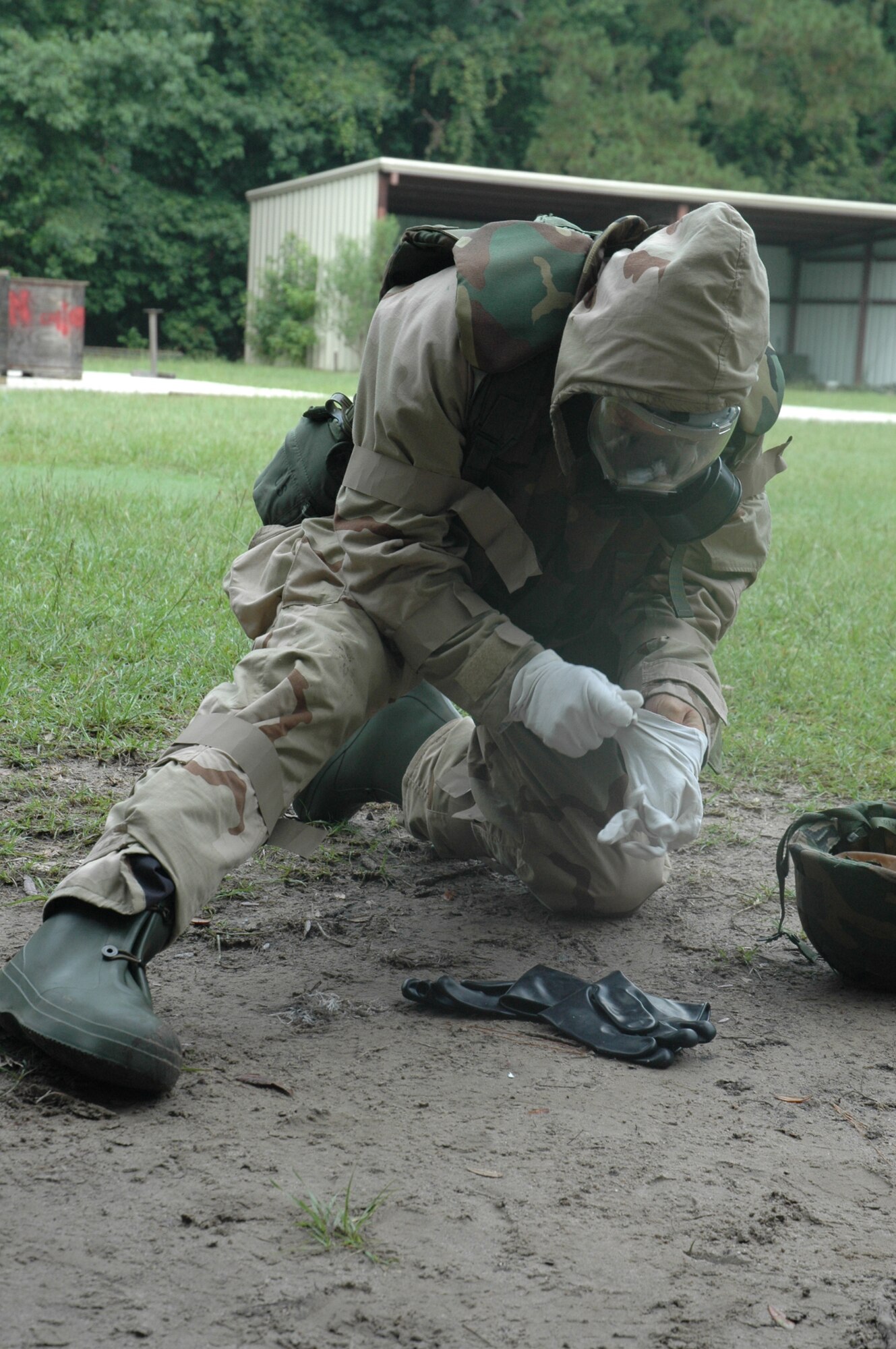Master Sergeant Jerry Goodwin rushes to suit up in his level four Mission Oriented Protective Posture gear (MOPP 4) in a two-minute time limit during Ability to Survive and Operate training held July 12. Members of the 315th Airlift Wing here at Charleston Air Force Base, S.C., are undergoing ATSO training in preparation for the upcoming Operational Readiness Inspection. (U.S. Air Force photo by Senior Airman Dani Pacheco)