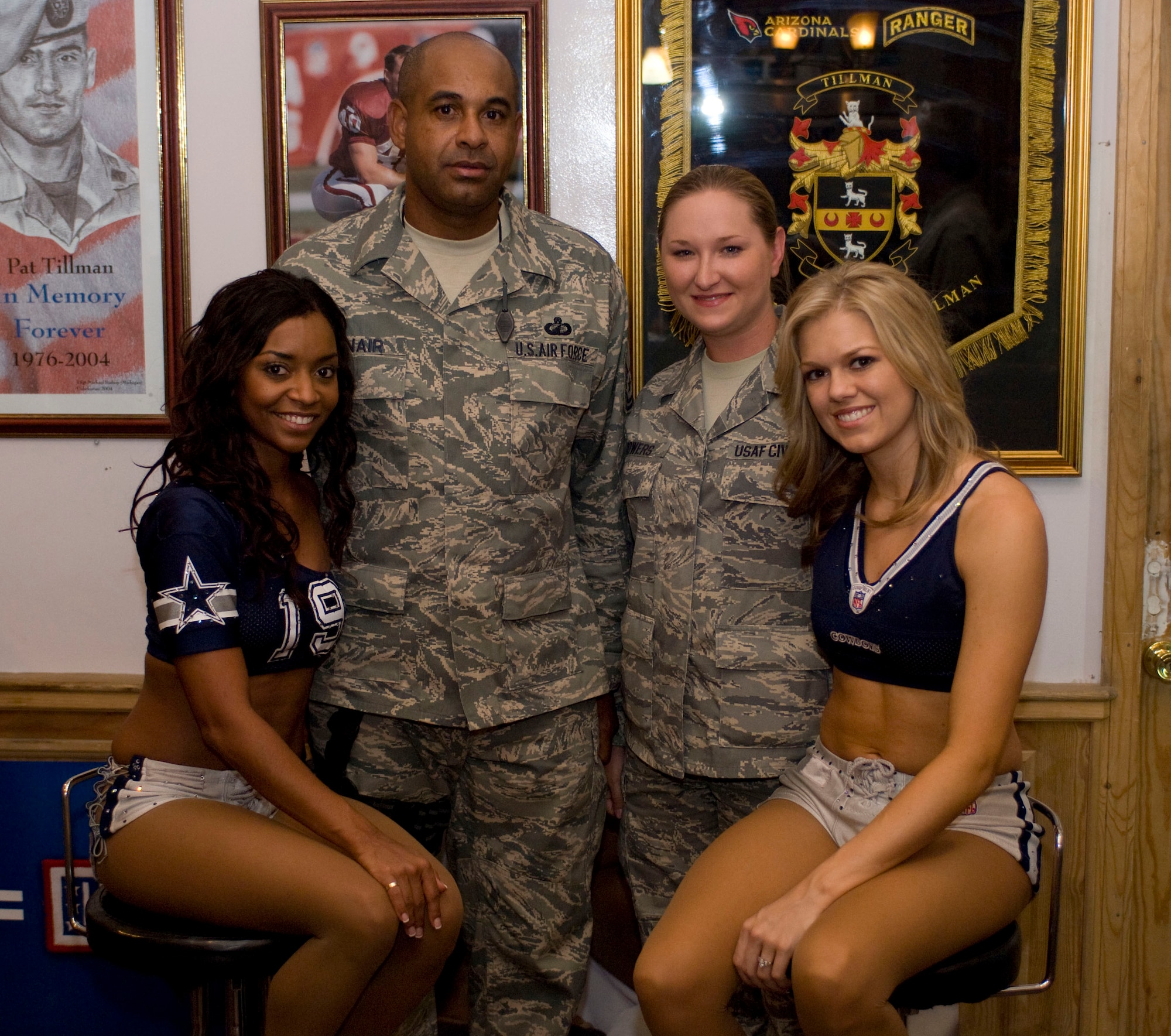 BAGRAM AIR FIELD, Afghanistan -- Master Sgt. Derrick McNair, from Gary, Ind., and Ms. Misty Bowers, from Vilonia, Ark., pose with Dallas Cowboys cheerleaders Deryn Derbigny and Christina Parker at the USO Tillman Center on July 11, 2008. Sergeant McNair is a paying agent for the 455th Air Expeditionary Wing and Ms. Bowers works for the Air Force Audit Agency. The two were given the opportunity to meet and have their photo taken with the cheerleaders during the USO Summer Tour. (U.S. Air Force photo by Staff Sgt. Samuel Morse)