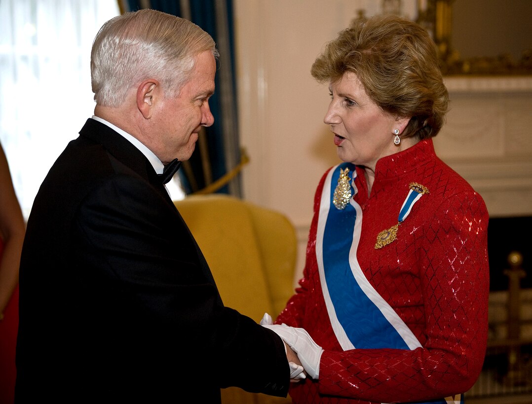 Defense Secretary Robert M. Gates shakes hands with Linda Gist Calvin, president general of the Daughters of the American Revolution, before the organization's National Defense Night at Constitution Hall in Washington, D.C., July 11, 2008. More than 3,000 Daughters of the American Revolution filled the organization's National Headquarters in Washington, D.C., for their annual convention, July 9 - 13, 2008.  