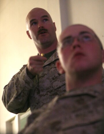 1st Lt. Darrell Brown, 31, the supply officer with the Warlords of Task Force 2nd Battalion, 2nd Marines, Regimental Combat Team 5, from Charlotte, N.C., teaches a debt management and investing class at Camp Al Qaâ??im, Iraq, July 13. Brown has prepared financial classes from the knowledge he has personally gained over the years. â??I donâ??t see why Marines have to make the same mistakes that I did, if they can learn from mine.â?? Brown said.