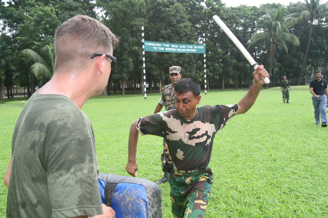 A Bangladeshi Rifles soldier swings his bayonet to suppress a simulated suspect after Marine instructors doused him with oleoresin capsicum (pepper) spray July 14 during Non-Lethal Weapons Executive Seminar 2008 here. The training provides a better understanding of the effects of pepper spray before it is employed.