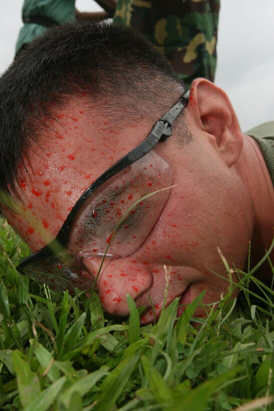 Sgt. Corey Gonzalez lies compliantly after a Bangladeshi soldier employed simulated pepper spray on him July 14 during Non-Lethal Weapons Executive Seminar 2008 here. Gonzalez is an assistant anti-terrorism force protection instructor with III Marine Expeditionary Force's Special Operations Training Group.