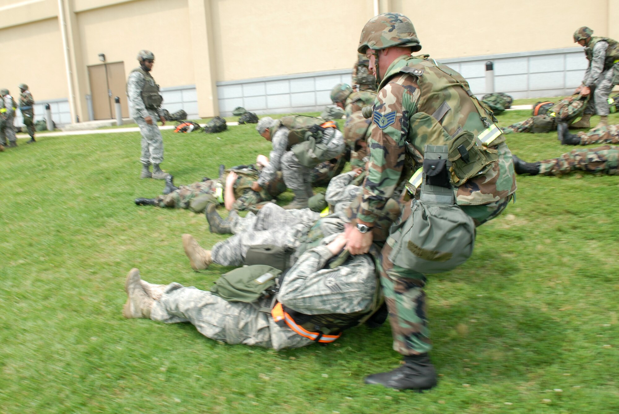 KUNSAN AIR BASE Republic of Korea -- Airmen perform the head drag by holding onto the flak fest and pulling their simultaed injured partner during the Wolf War Day here July 14. The War Day provided 8th Fighter Wing Airmen with classroom-based and hands-on training in preparation for an upcoming peninsula-wide Operational Readiness Exercise.(US Air Force Photo by: Senior Airman Angela Ruiz)