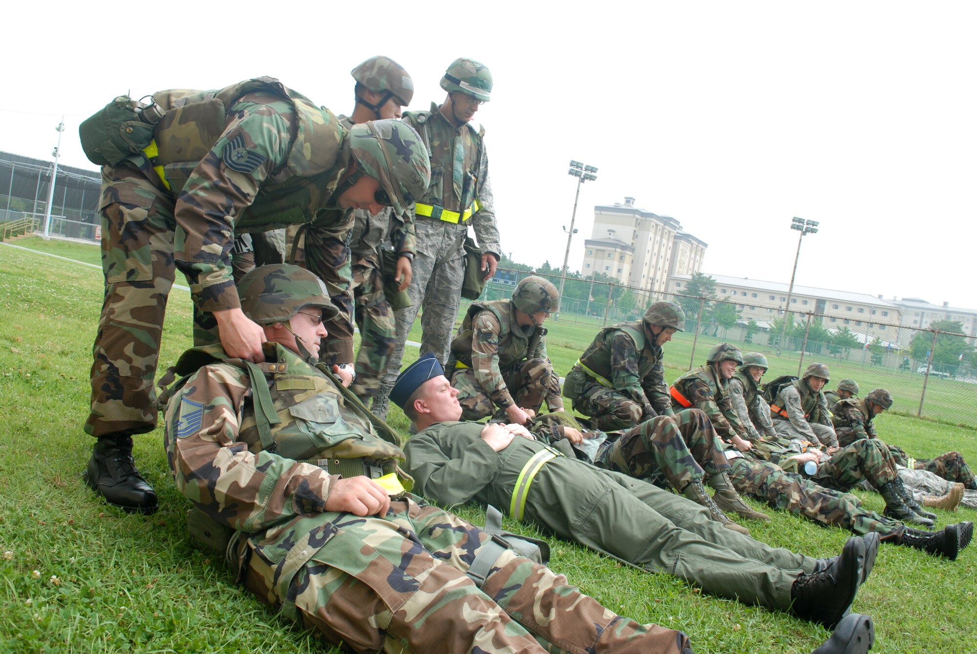 KUNSAN AIR BASE Republic of Korea -- Airmen perform the head drag by holding onto the flak fest and pulling their simulated injured partner during the Wolf War Day here July 14. The War Day provided 8th Fighter Wing Airmen with classroom-based and hands-on training in preparation for an upcoming peninsula-wide Operational Readiness Exercise.(US Air Force Photo by: Senior Airman Angela Ruiz)