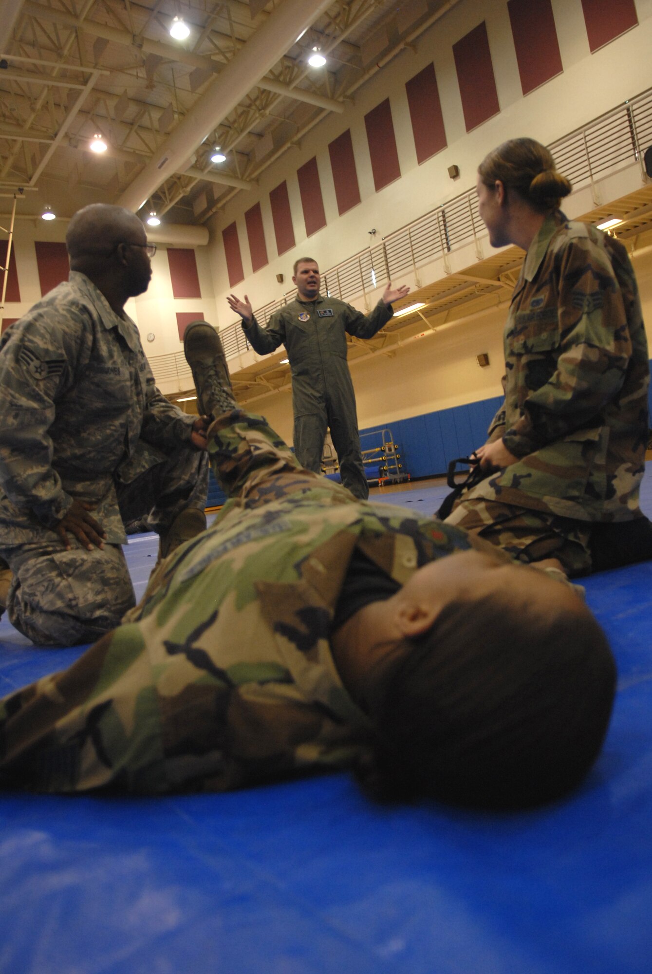 KUNSAN AIR BASE Republic of Korea -- Senior Airmen Leon Jones and Ashley Young, 8th Logistics readiness Squadron, practice Self Aid Buddy Care on Tech. Sgt. Wyshell Boyd, under the direction of Staff Sgt. Daniel Nored, and Independent Duty Medical Technician with the 35th Fighter Squadron here July 14. Sergeant Nored is giving a refresher on self aid buddy care and chemical agents during the Wolf War Day. The War Day provided 8th Fighter Wing Airmen with classroom-based and hands-on training in preparation for an upcoming peninsula-wide Operational Readiness Exercise.(US Air Force Photo by: Senior Airman Angela Ruiz)