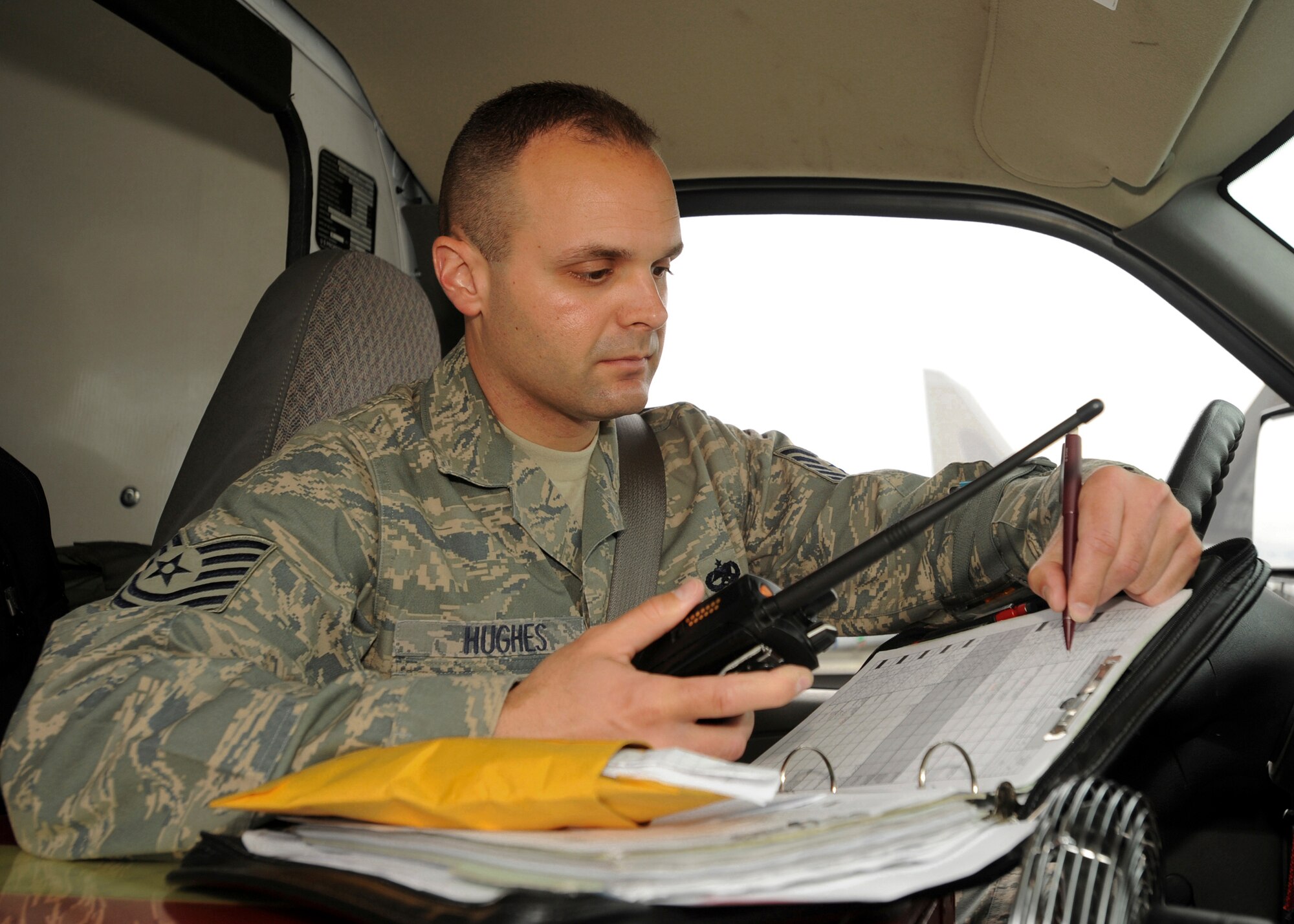 ELMENDORF AIR FORCE BASE, Alaska -- Tech. Sgt. Jason Hughes, 3rd Aircraft Maintenance Squadron, records information as reported to him on the radio while performing an F-22A Raptor inspection July 10. Sergeant Hughes was named as one of 12 Outstanding Airmen of the Year. (U.S. Air Force photo/Airman 1st Class Laura Turner)