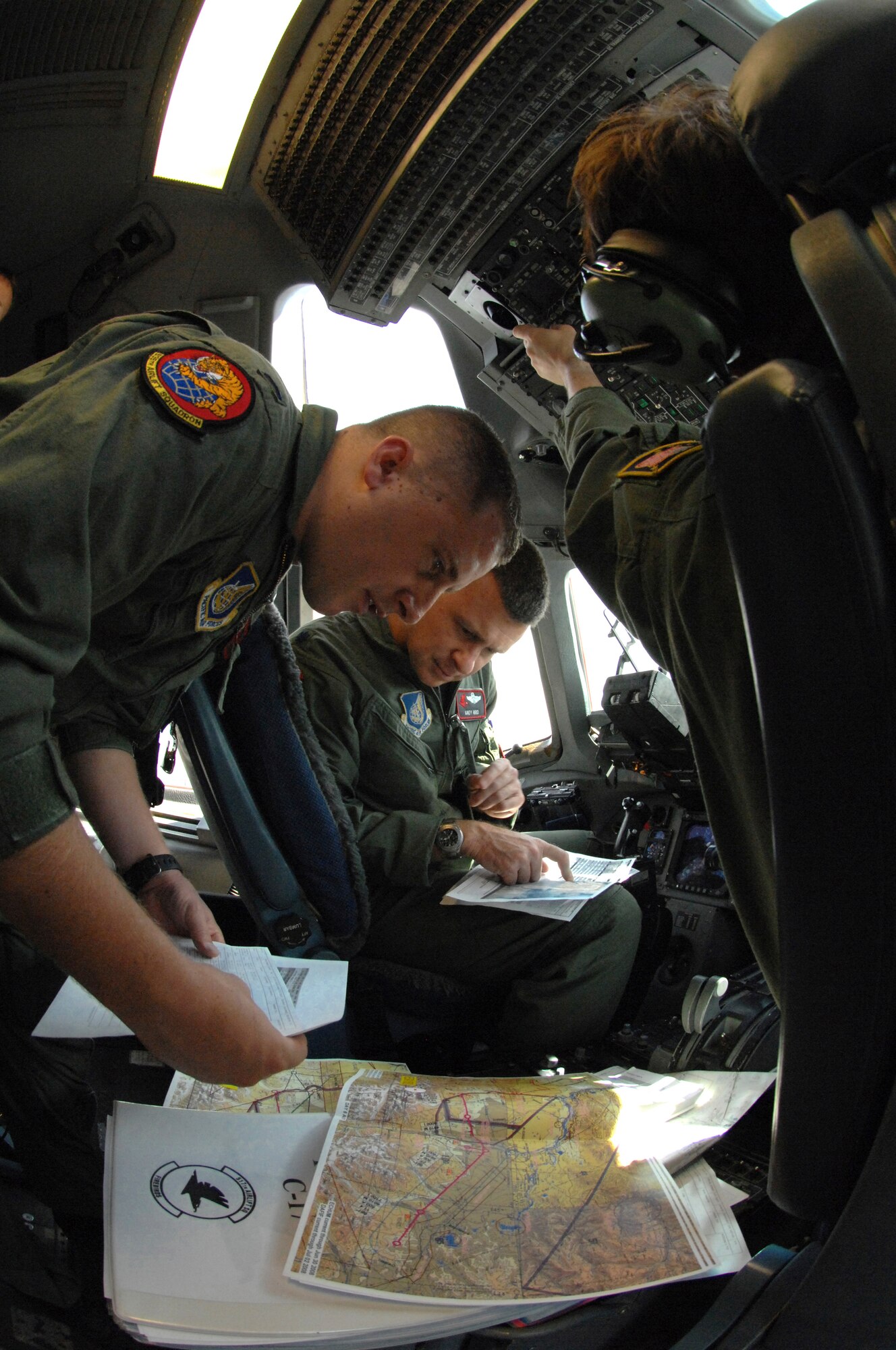 ELMENDORF AIR FORCE BASE, Alaska -- Lt. Col. Andy Hird, 517th Airlift Squadron director of operations, and 1st Lt. Joe Aubert, 535th Airlift Squadron from Hickam AFB, Hawaii, preflight the C-17 for the first Alaskan dirt landing. In support of RED FLAG-Alaska, the pilots verify the low-level route prior to intial take off. (U.S. Air Force photo/Airman 1st Class Morgan Sneed)