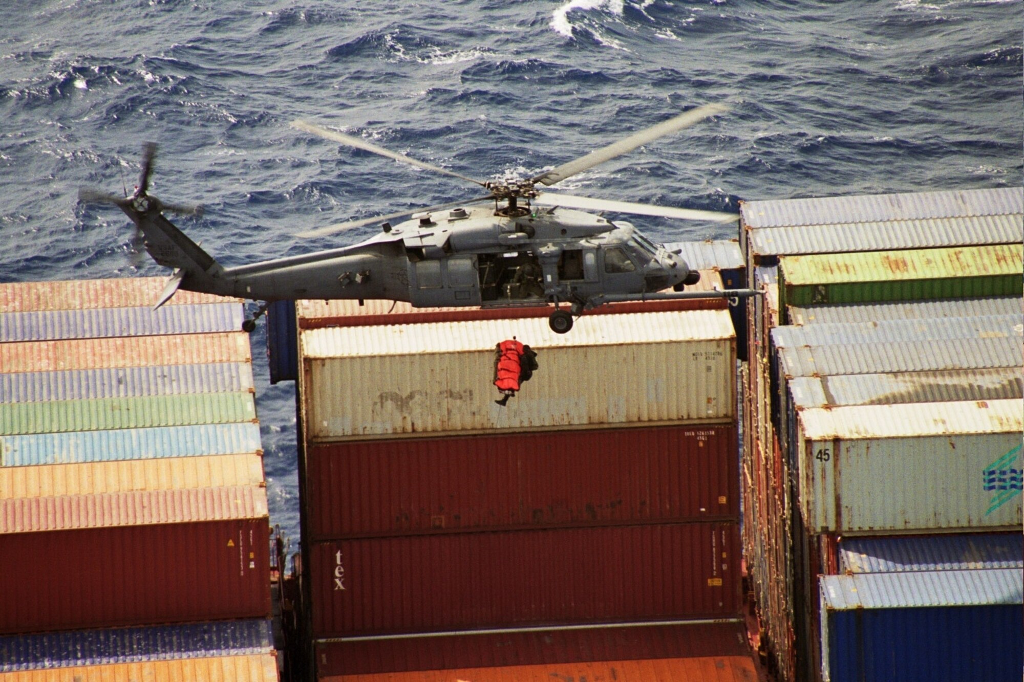 A pararescueman from the 131st Rescue Squadron hoists the patient from the APC Peru cargo container ship in to the hovering HH-60G Pave Hawk June 18, 2008. The 129th was credited with its 559th save. (Air Force photo by Tech. Sgt. Brock Woodward)