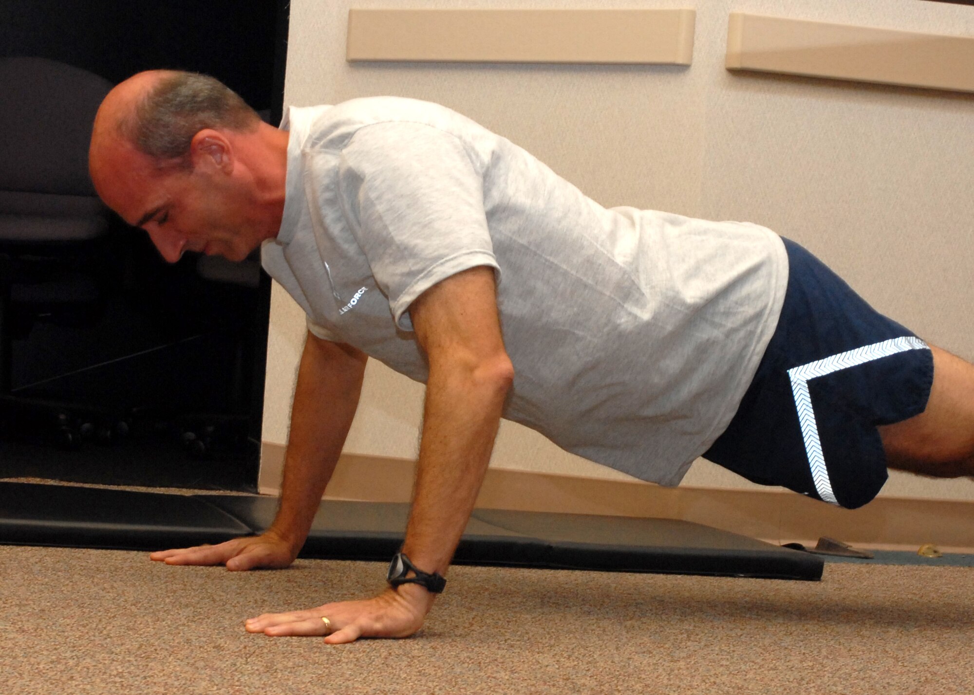 Air Force Reservist Col. Jeffrey "Sal" Mineo, commander of Detachment 2 and the future 940th Command and Control Wing commander, does a pushup as part of his Air Force physical fitness test July 13, 2008 at Beale Air Force Base, Calif.; the colonel scored a perfect 100 percent.  Airmen must constantly hone their physical abilities to withstand and overcome the demanding rigors of deployment and combat. (U.S. Air Force photo/Stacey Knott)