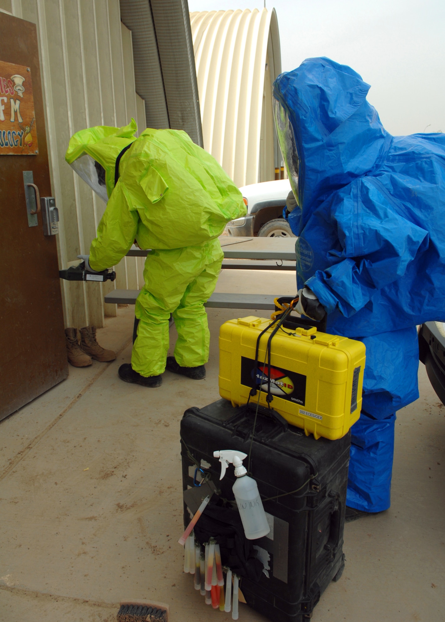 Senior Airmen Krista McVicar and Michael Blair, 332nd Expeditionary Civil Engineer Squadron emergency management equipment technicians at Joint Base Balad, Iraq, respond during a battle drill to an unidentified substance in a facility here.  Emergency managers must identify questionable substances and employ the proper procedures needed to secure the area. Airman McVicar is deployed from Davis-Monthan Air Force Base, Ariz.; Airman Blair is deployed from McGuire AFB, N.J. (U.S. Air Force photo/Senior Airman Julianne Showalter)