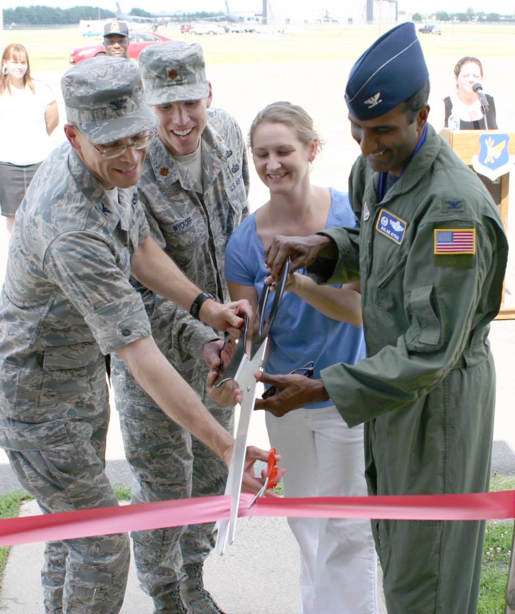 From left, Col. Michael Hutchison, former 305th Mission Support Group commander, Maj. Christopher Wyckoff, 305th Mission Support Squadron commander, Betsy Conzo, Airman & Family Readiness Center community readiness consultant, and Col. Balan Ayyar, 305th Air Mobility Wing commander, officially reopen the Airmen's Attic July 11. The attic has been closed for renovations since May, during which time the attic was completely redesigned, painted and carpeted. (U.S. Air Force photo/Senior Airman Danielle Johnson)