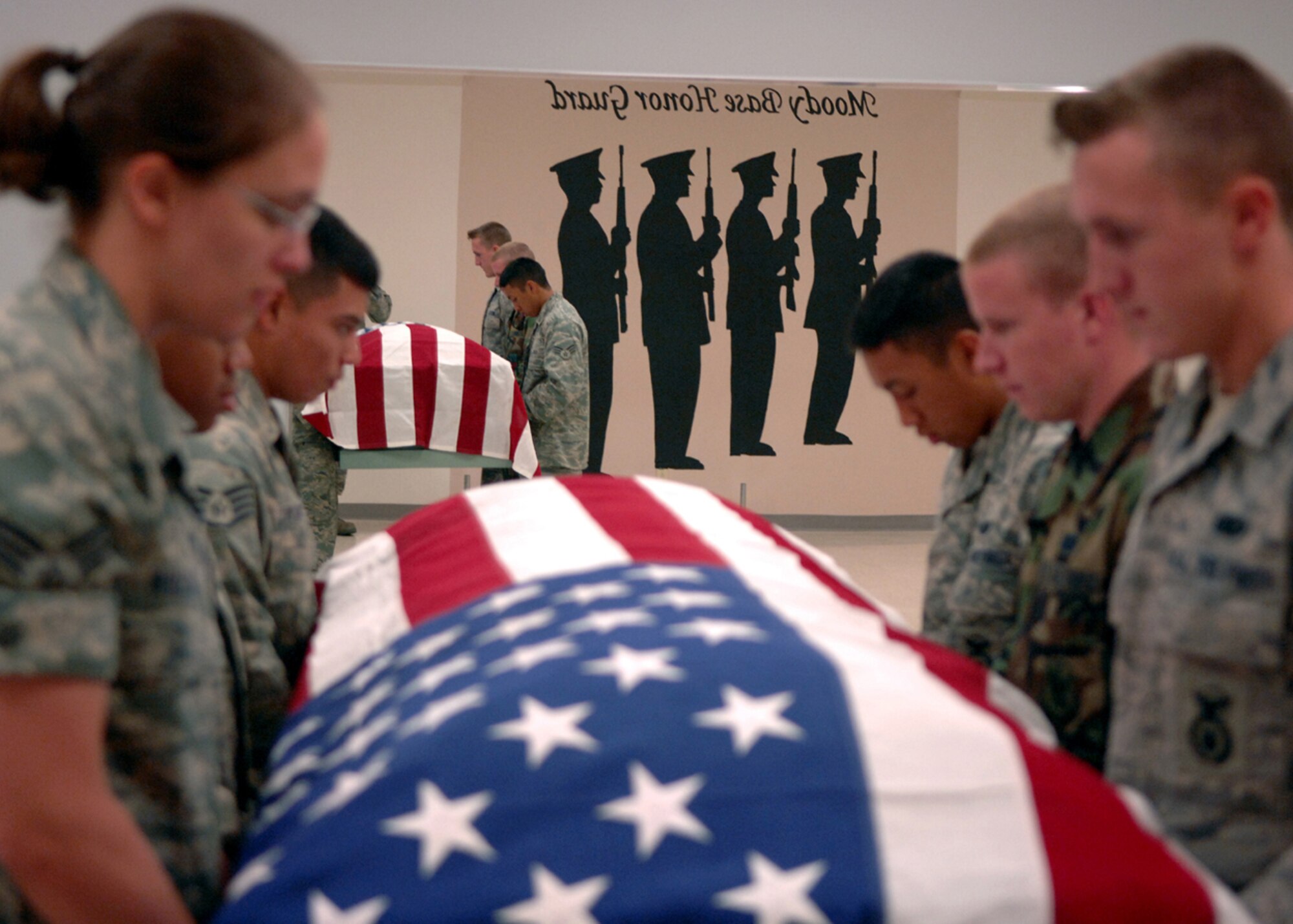 MOODY AIR FORCE BASE, Ga. – The Moody Air Force Base Honor Guard holds a casket and prepares for an order during a practice session here July 10. In order for honor guard Airmen to look and move as one unit they must practice until each action is second nature. (U.S. Air Force photo by Airman Joshua Green)   
