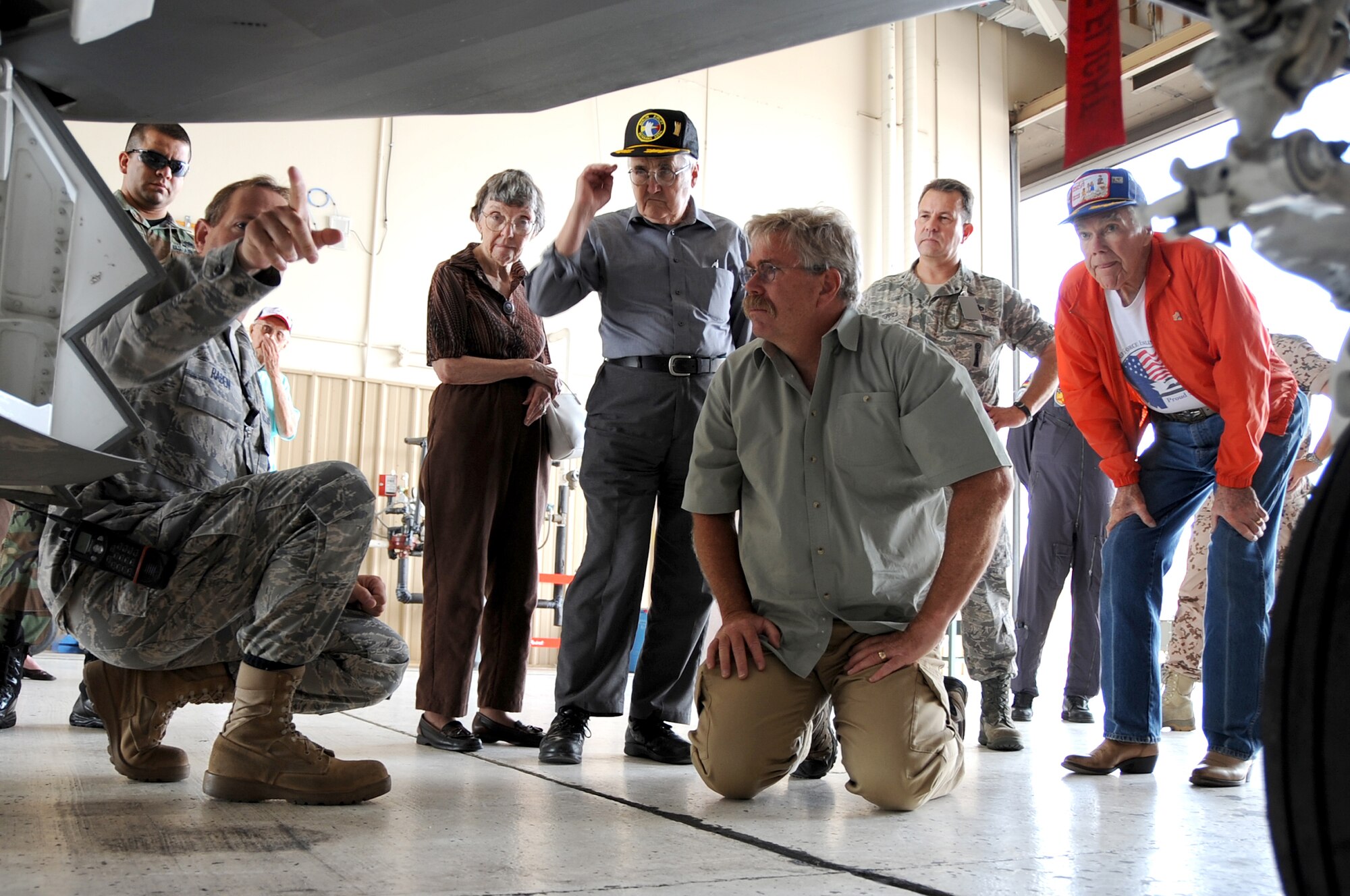Senior Master Sgt. Neal Raben, 49th Aircraft Maintenance Squadron, explains characteristics of an F-22A Raptor to Berlin Airlift veterans and their family. The veterans were visiting Holloman in commemoration of the Berlin Airlifts 60th Anniversary. (U.S. Air Force photo/Staff Sergeant Chris Flahive)