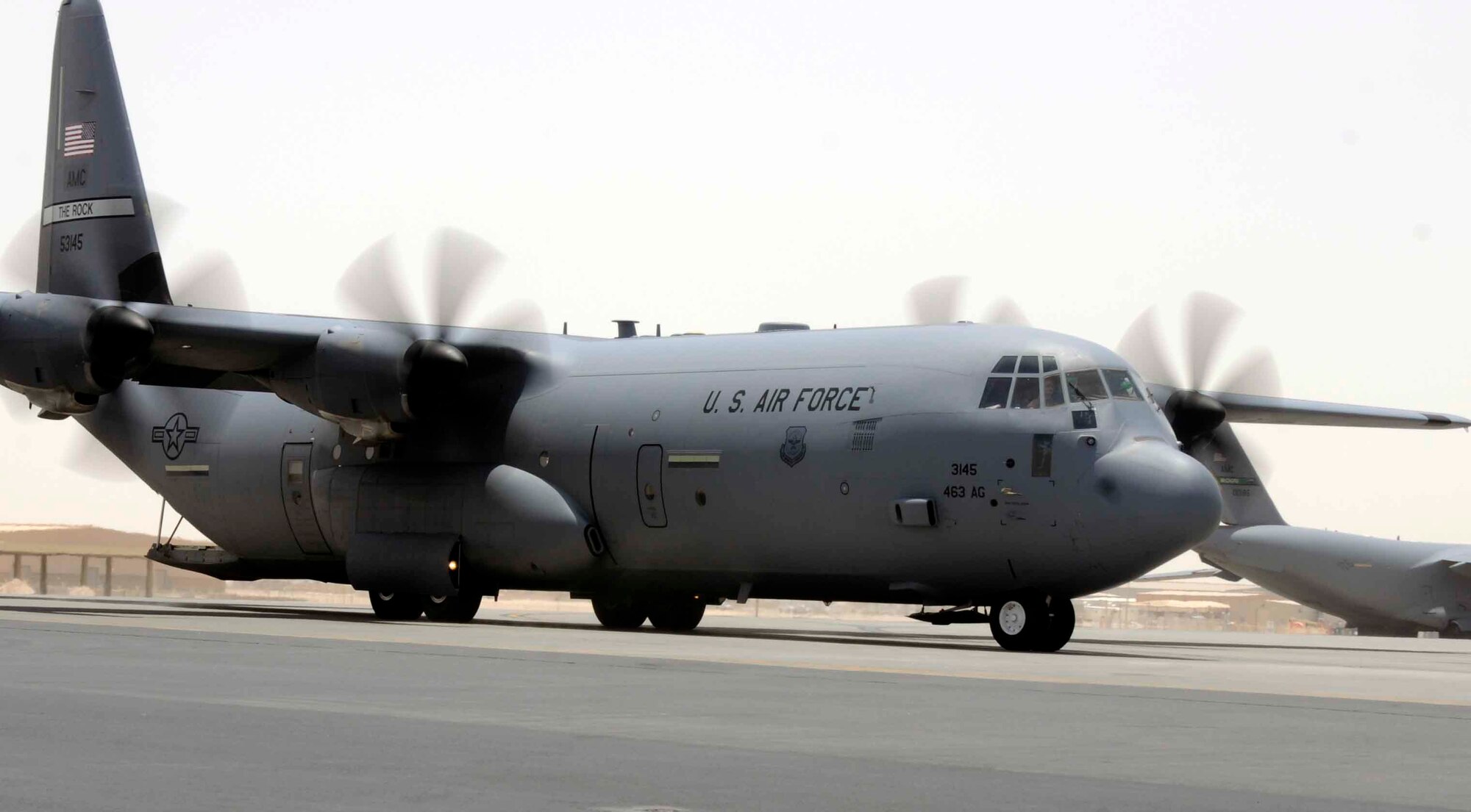 SOUTHWEST ASIA -- A C-130 Hercules prepares for loading July 8 here. Using its aft loading ramp and door the C-130 can accommodate a wide variety of oversized cargo, including everything from utility helicopters and six-wheeled armored vehicles to standard palletized cargo and military personnel. In an aerial delivery role, it can airdrop loads up to 42,000 pounds or use its high-flotation landing gear to land and deliver cargo on rough, dirt strips. (U.S Air Force photo/Senior Airman Domonique Simmons)