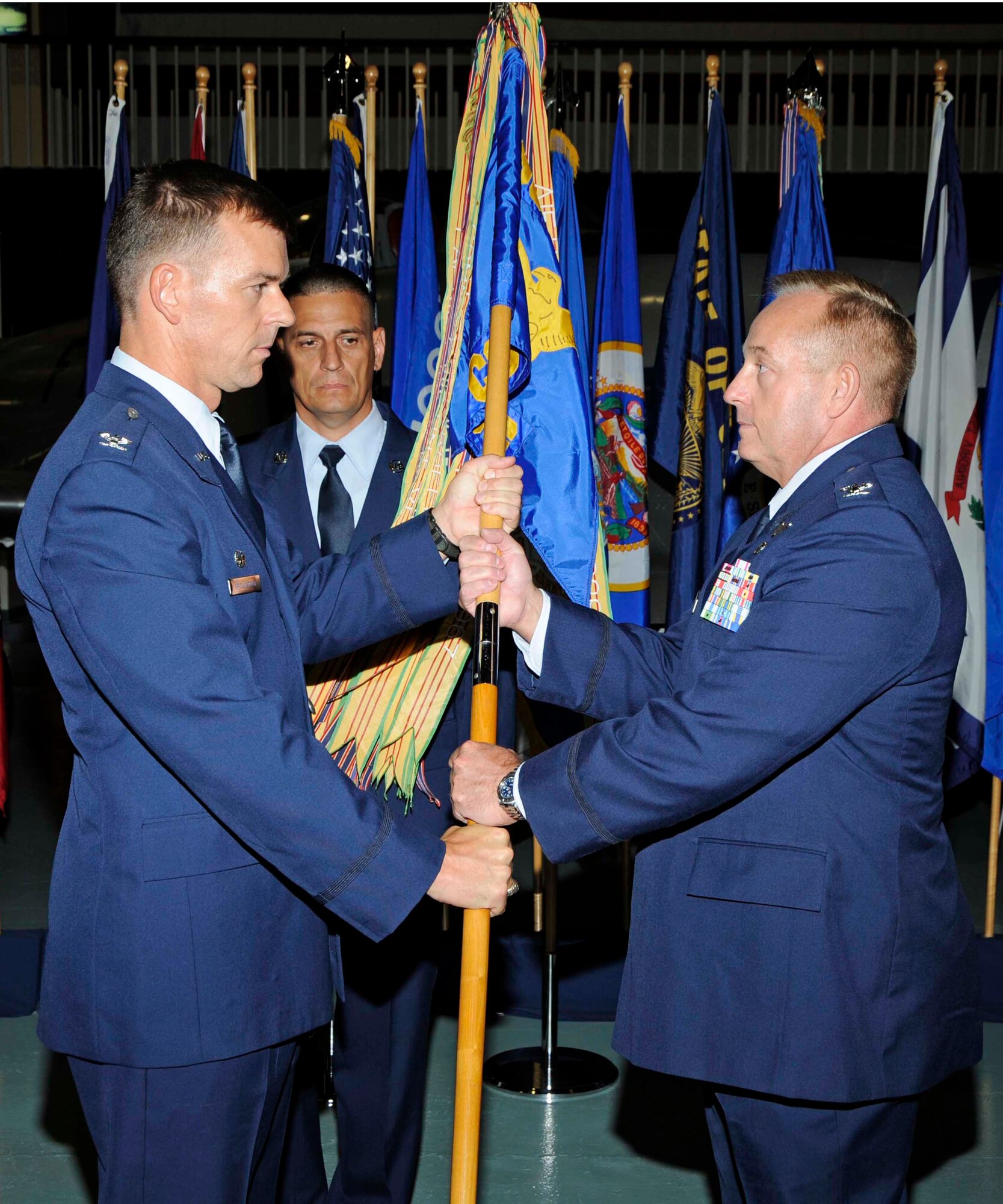 Col. Bruce McClintock, 96th Air Base Wing commander, passes the flag to Col. Steven O'Rear, the new commander of the 96th Communications Group. (USAF photo by Mike Fleck)