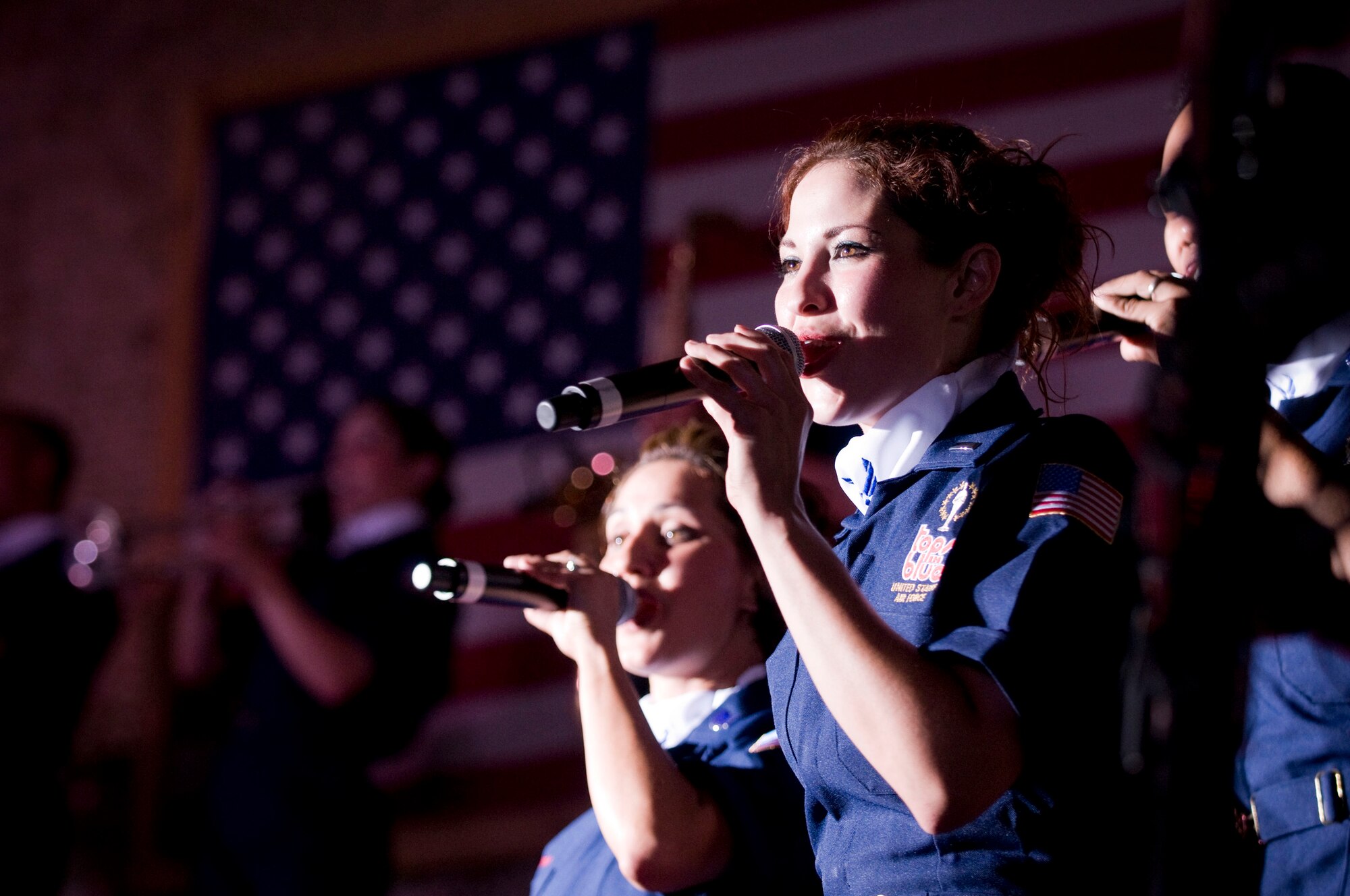 BAGRAM AIR FIELD, Afghanistan -- First Lt. Darci Day, vocalist for Tops in Blue, sings during a performance here on July 13, 2008. Lieutenant Day is an air battle manager and air weapons officer for the 960th Airborne Air Control Squadron, Tinker Air Force Base, Okla., and hails from Hot Springs, S.D. (U.S. Air Force photo by Staff Sgt. Samuel Morse)