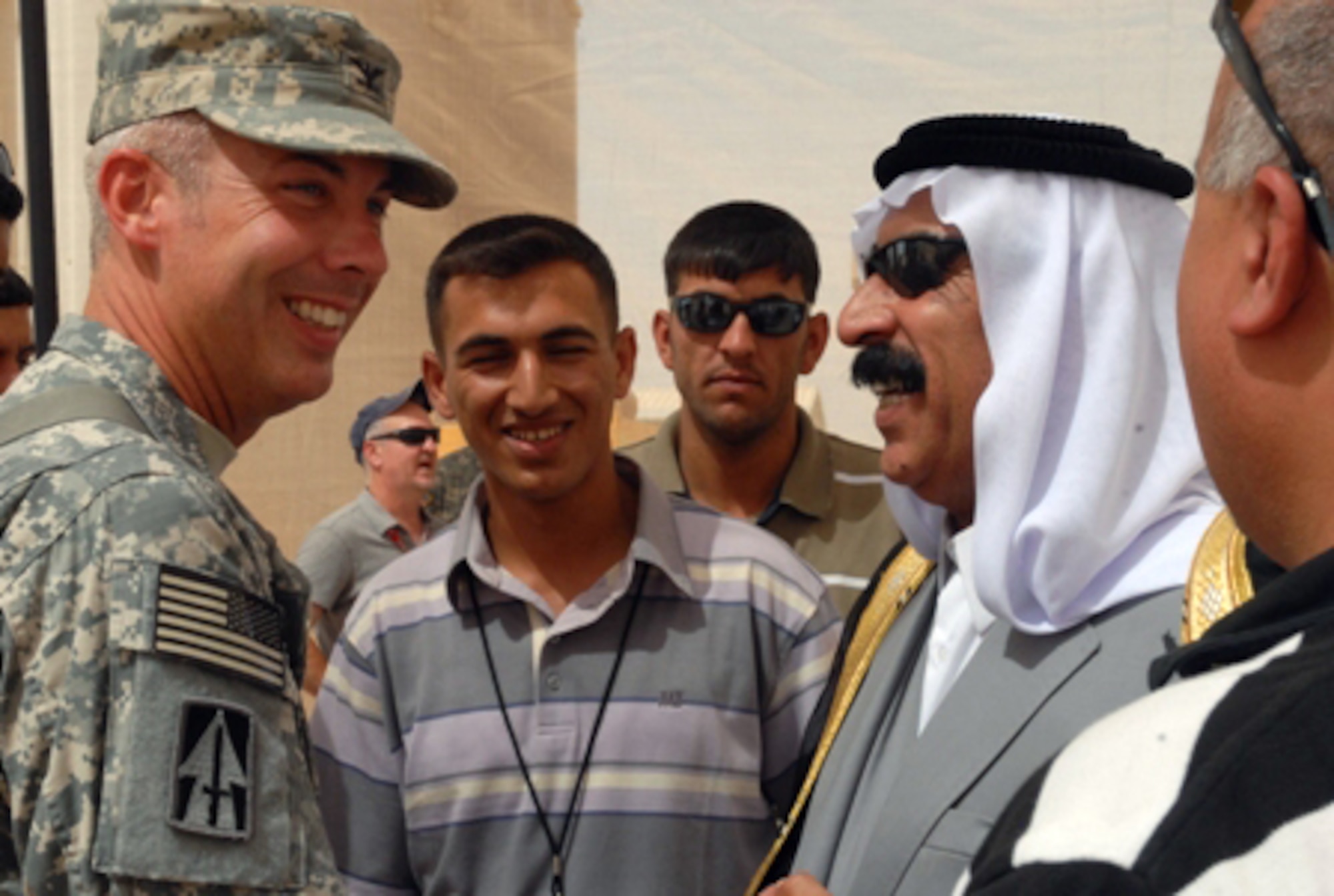 JOINT BASE BALAD, Iraq -- Army Col. Kenneth Newlin greets local leader Sheikh Saad Hasan Altememy during a ribbon-cutting ceremony for an Iraqi-run recycling center here July 11. The 76th Infantry Brigade Combat Team, along with many sheikhs from the surrounding Balad area, are working together through the Iraqi-Based Industrial Zone program. The initiative compliments the Multi-National Forces-Iraq's mission by providing safe, secure jobs for local Iraqis and by giving them additional contracting opportunities normally reserved for larger, foreign corporations. Colonel Newlin is the 76th Infantry BCT's deputy commander. (U.S. Army Photo/Sgt. Robert G. Cooper III)