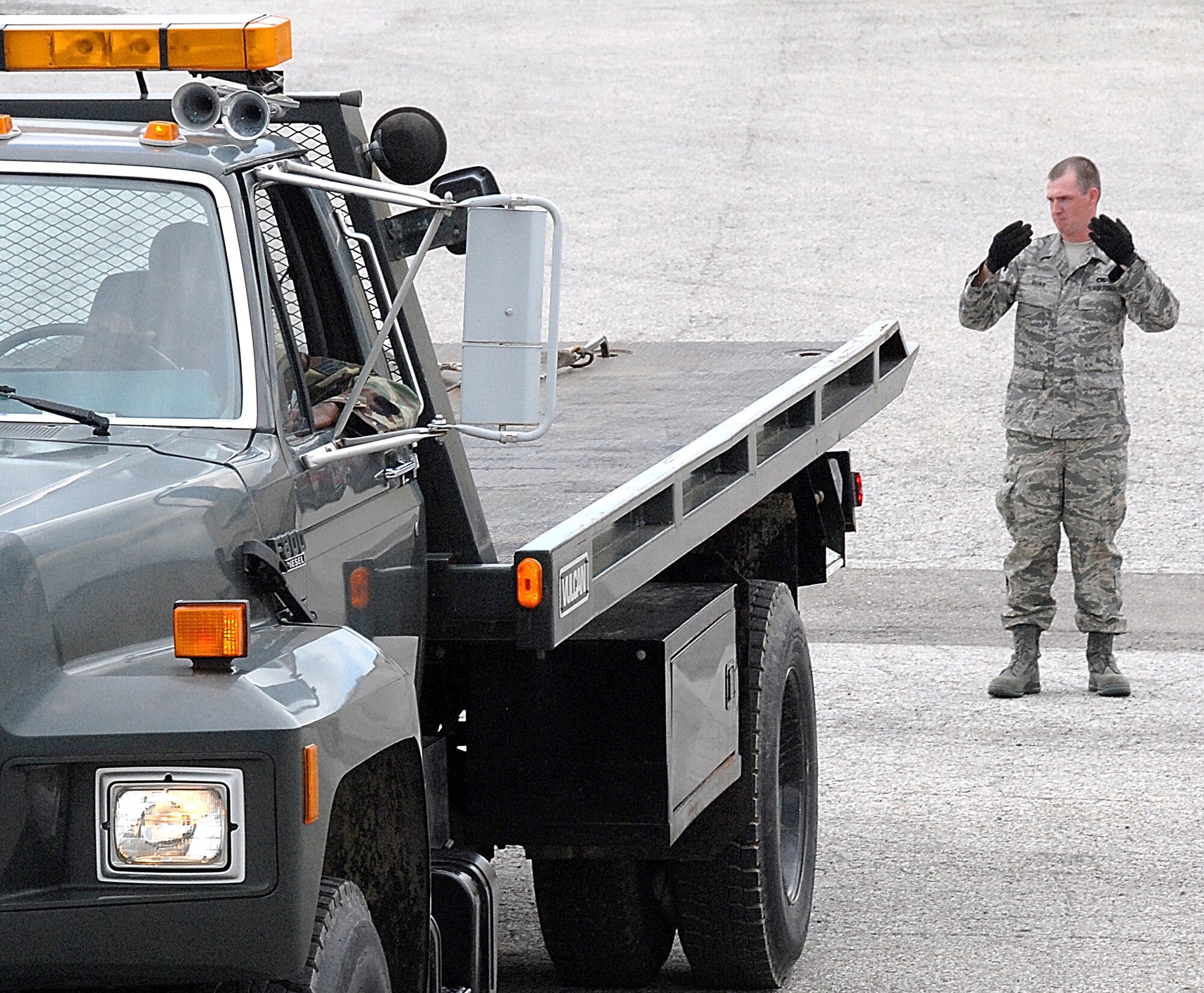 Staff Sgt. Josh Burr, marshals Senior Airman Carnell Alford, as he backs a vehicle in the transportation compound. Sergeant Burr and Airman Alford are vehicle operators with the 442nd Logistics Readiness Squadron, which is part of the 442nd Fighter Wing, an Air Force Reserve Command A-10, Thunderbolt II, fighter unit based at Whiteman Air Force Base, Mo. (US Air Force photo/MSgt. Bill Huntington)