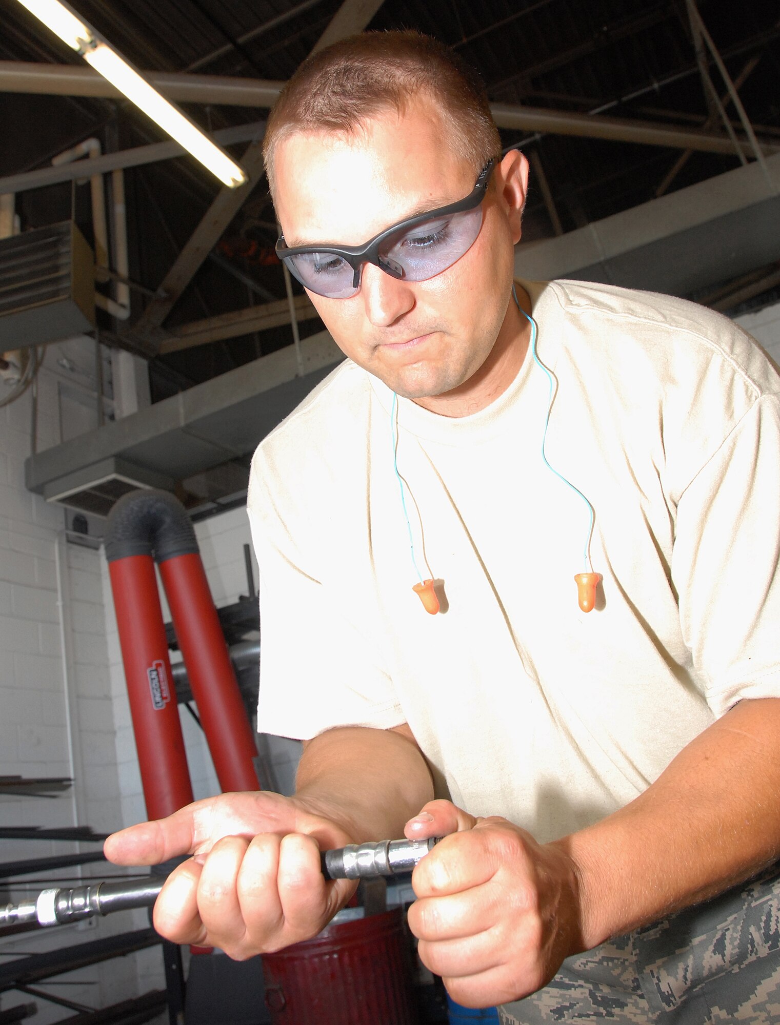 Staff Sgt. Clay Hudson, a vehicle mechanic with the 442nd Logistics Readiness Squadron, adjusts a fitting on an air conditioning repair job. The 442nd LRS is a part of the 442nd Fighter Wing, an Air Force Reserve Command A-10, Thunderbolt II, fighter unit based at Whiteman Air Force Base, Mo. (US Air Force photo/MSgt. Bill Huntington)