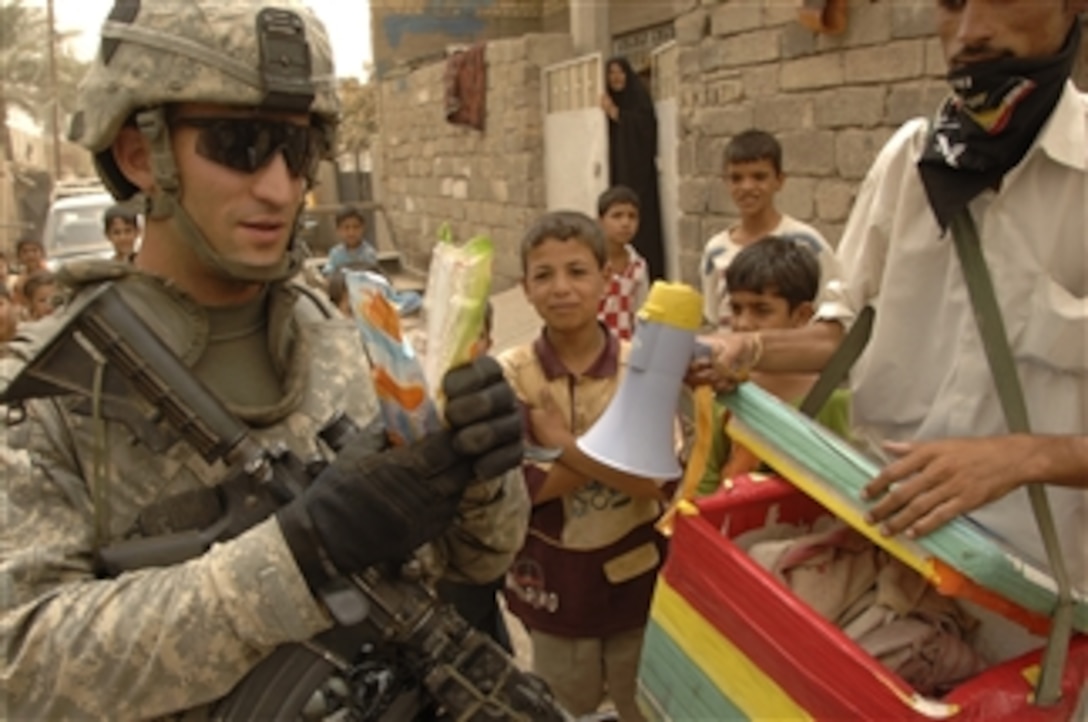 U.S. Army Capt. Michael Kolton buys ice cream from a street vendor during a combined patrol with Iraqi police officers in Baghdad, Iraq, on July 8, 2008.  Kolton is platoon leader, 4th Platoon, Bravo Troop, 1st Squadron, 75th Cavalry, 2nd Brigade Combat Team, 101st Airborne Division.  