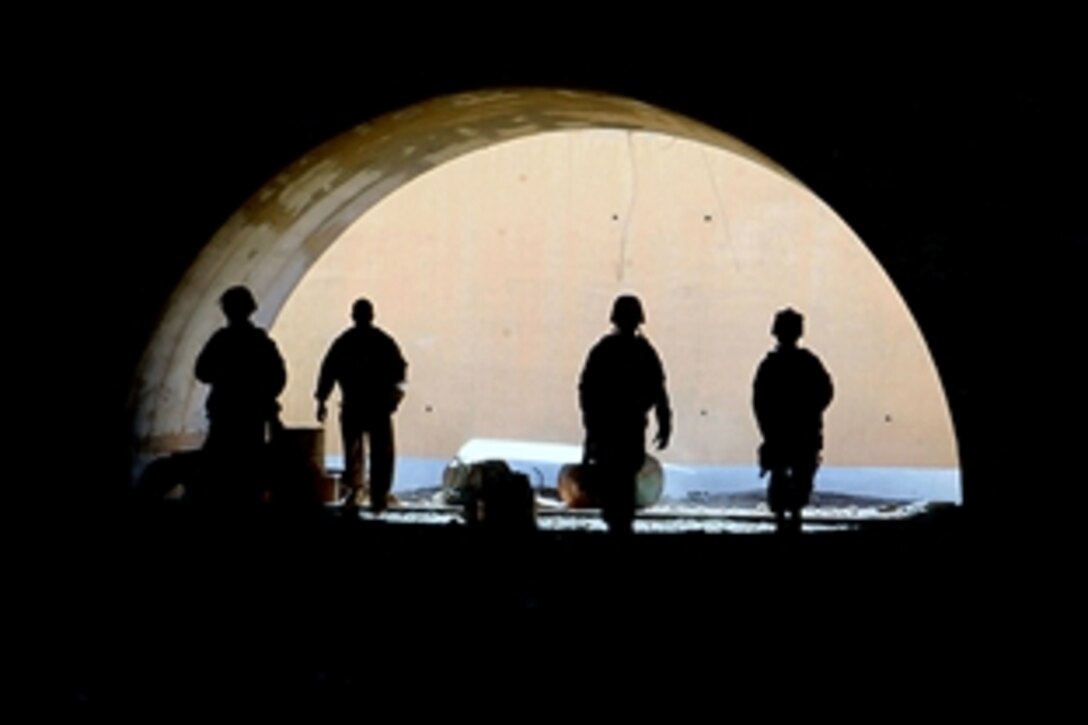 U.S. Marines search a large hangar at a future Iraqi air base in western Anbar province, Iraq, July 3, 2008. The Marines are assigned to Regimental Combat Team 5's Charlie Company, 2nd Light Armored Reconnaissance Battalion and are providing security for combat engineers during a survey of the area. 
