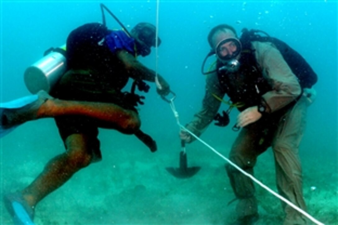 U.S. Navy Petty Officer 1st Class Overton Pierce, right, and Constable Vincent Gregoire, a regional security diver from the Common Wealth of Dominica, perform searching techniques off the coast of Antigua during Navy Diver-Global Fleet Station 2008, July 10, 2008. 