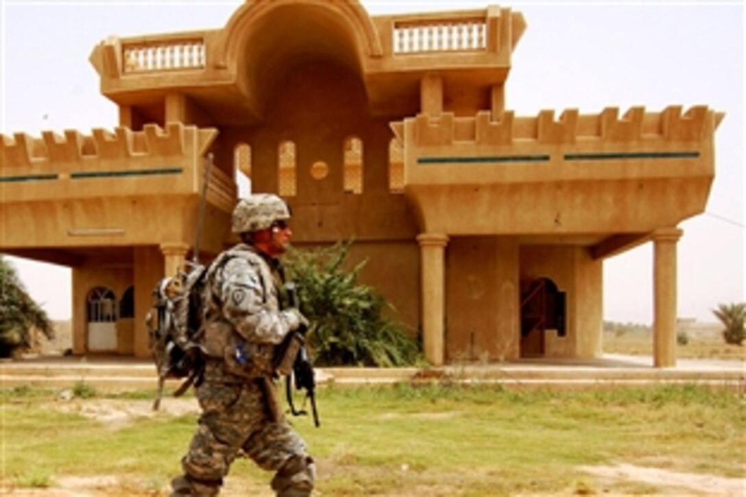 U.S. Army Spc. Adam Brown patrols through a neighborhood in the Taji Qada, northwest of Baghdad, July 9, 2008, en route to a tribal sheik’s house to discuss essential services and grants. Brown is an infantryman assigned to the 25th Infantry Division's Company B, 1st Battalion, 27th Infantry Regiment, 2nd Stryker Brigade Combat Team, Multi-National Division – Baghdad.

