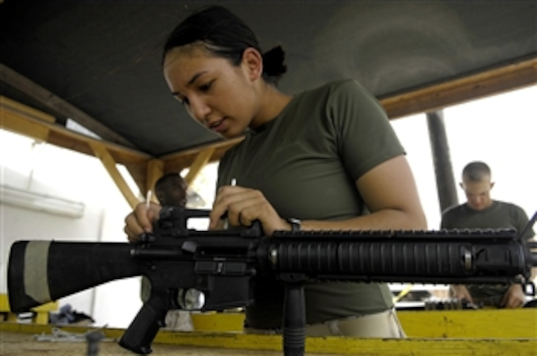 U.S. Marine Corps Cpl. Sheryl Verhulst cleans her M-16 assault rifle at Camp Lemonier, Djibouti, on July 12, 2008.  Verhulst is assigned to the 8th Provisional Security Company and is deployed in support of Combined Joint Task Force - Horn of Africa.  