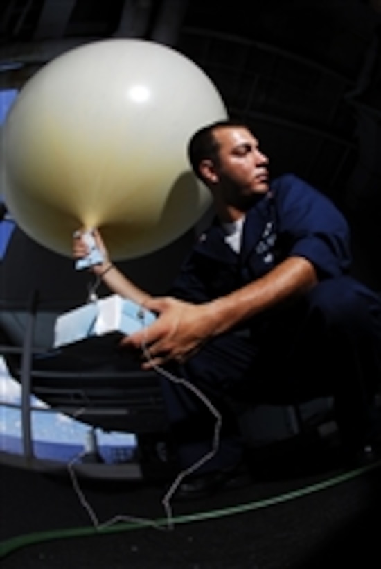 U.S. Navy Petty Officer 2nd Class Kristopher Rodriguez prepares to release a weather balloon from the fantail of the aircraft carrier USS Kitty Hawk (CV 63) while underway in the Pacific Ocean participating in the exercise Rim of the Pacific 2008 on July 9, 2008.  The exercise is biannual and hosted by the U.S. Pacific Fleet bringing together military forces from Australia, Canada, Chile, Peru, Japan, the Netherlands, Singapore, the United Kingdom and the Republic of Korea.  
