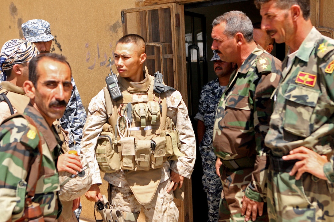 2nd Lt. Nathan P. Phan, the platoon commander for 3rd Platoon, Company F, 2nd Battalion, 24th Marine Regiment, speaks with Col. Khamis, the Sabbatine Battalion commanding officer, during a meeting July 14.