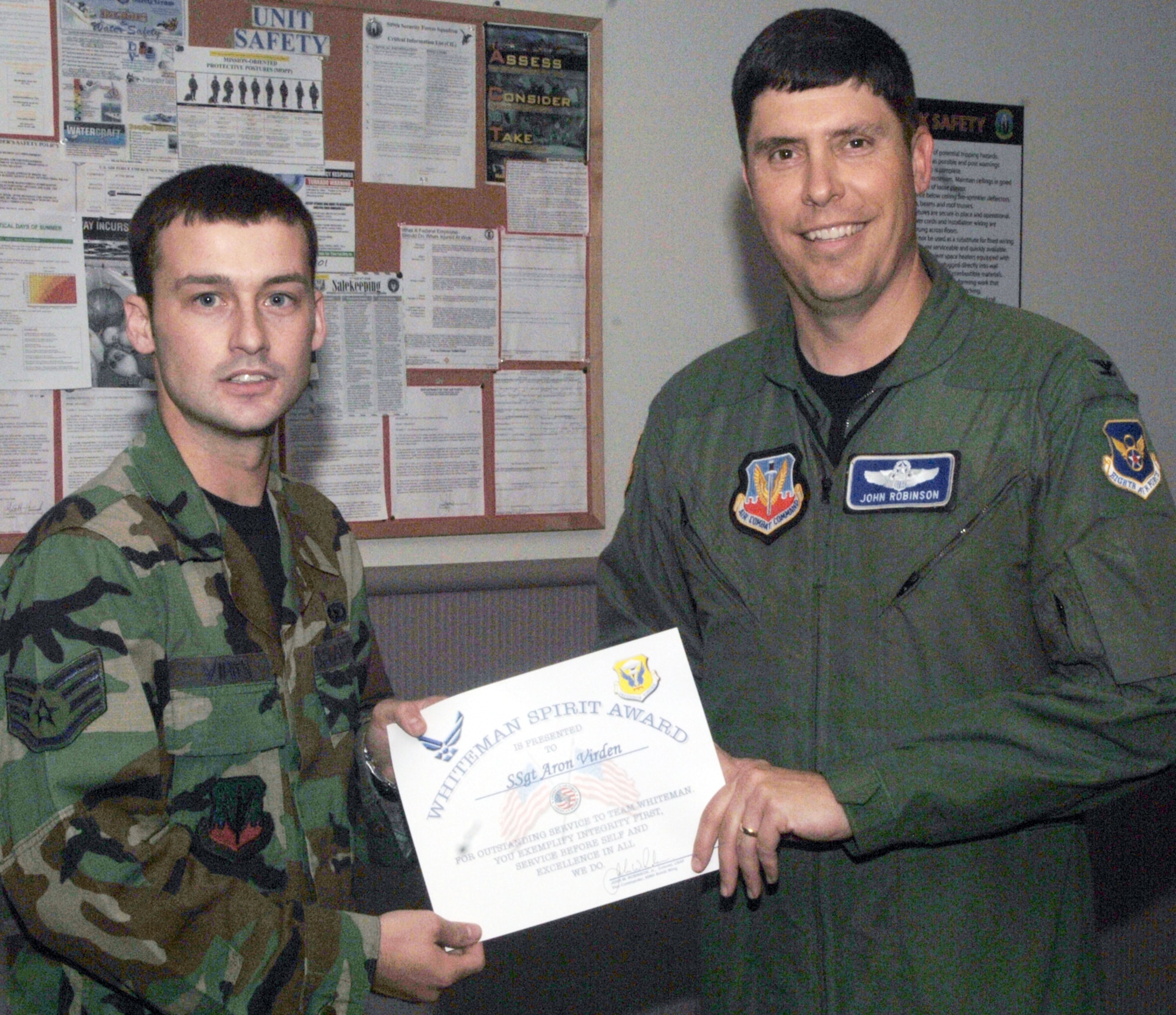 Staff Sgt. Aron Virden,  509th Security Forces Squadron, receives the Whiteman Spirit Award from Col. John Robinson, 509th Bomb Wing vice commander, July 8.